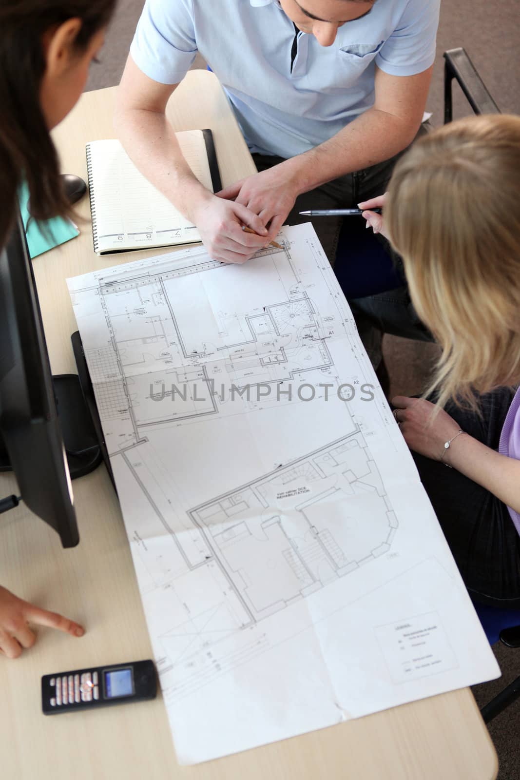 People looking at the layout of a house