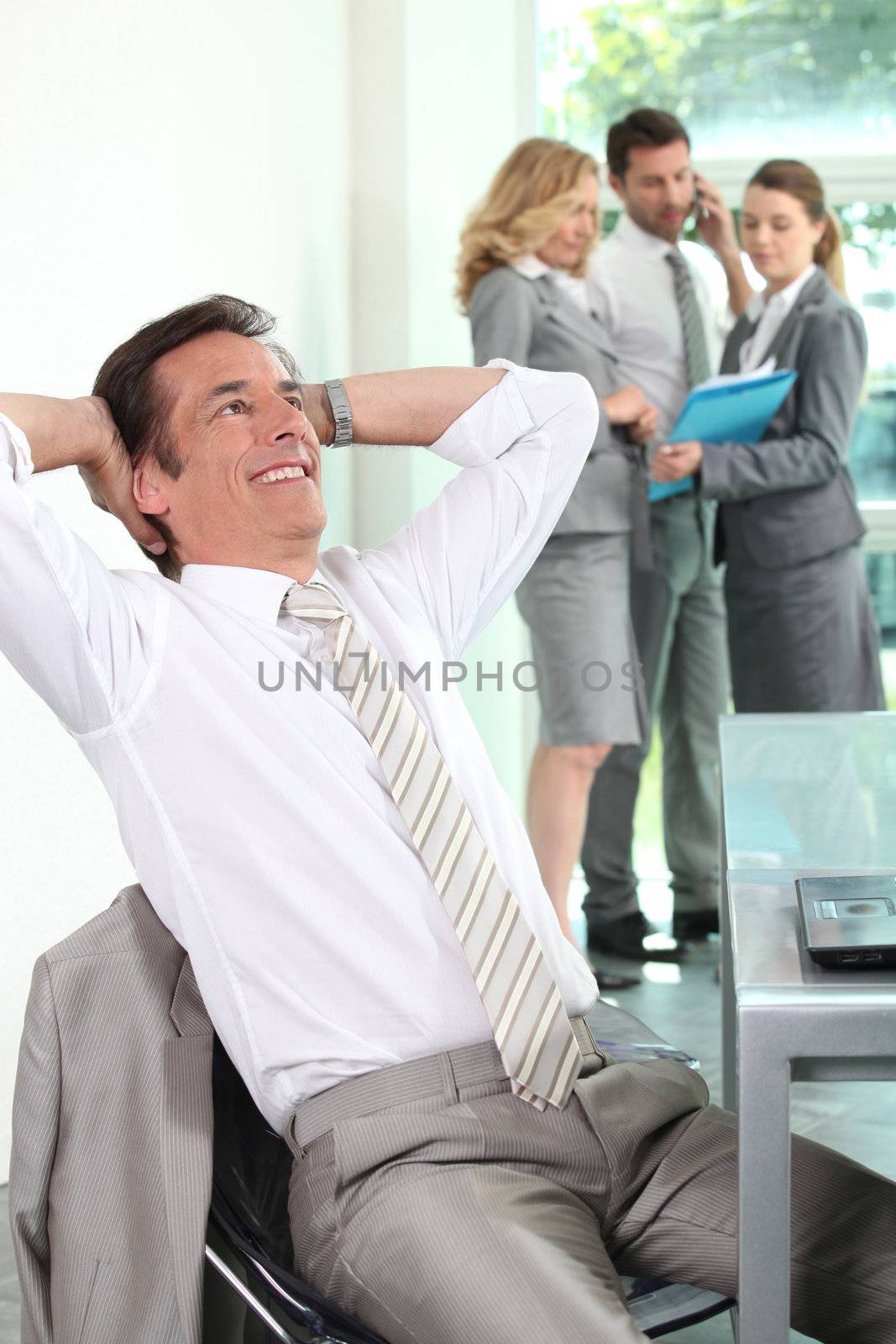 Businessman leaning back by phovoir