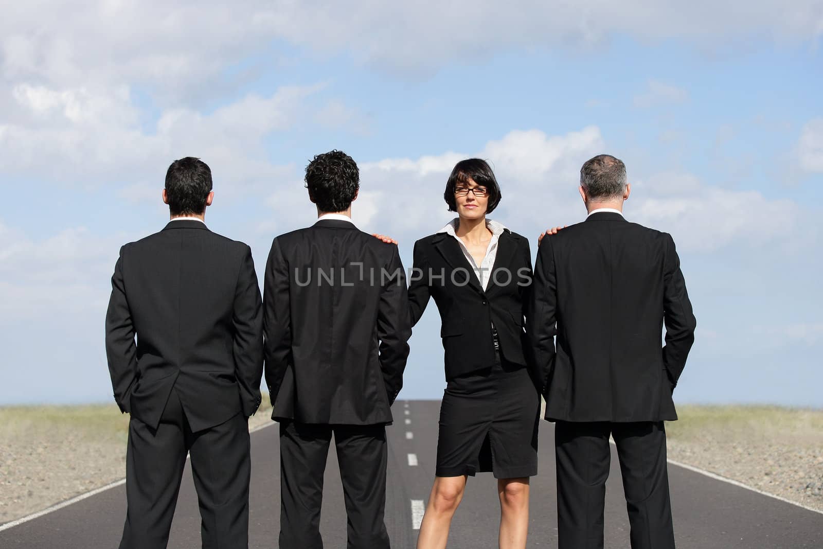Businesswoman with businessmen on airport runway by phovoir