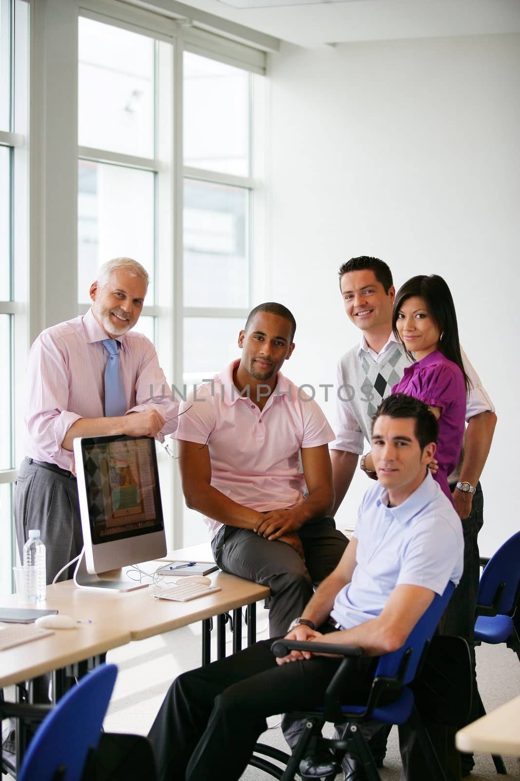 Group of colleagues gathered around computer