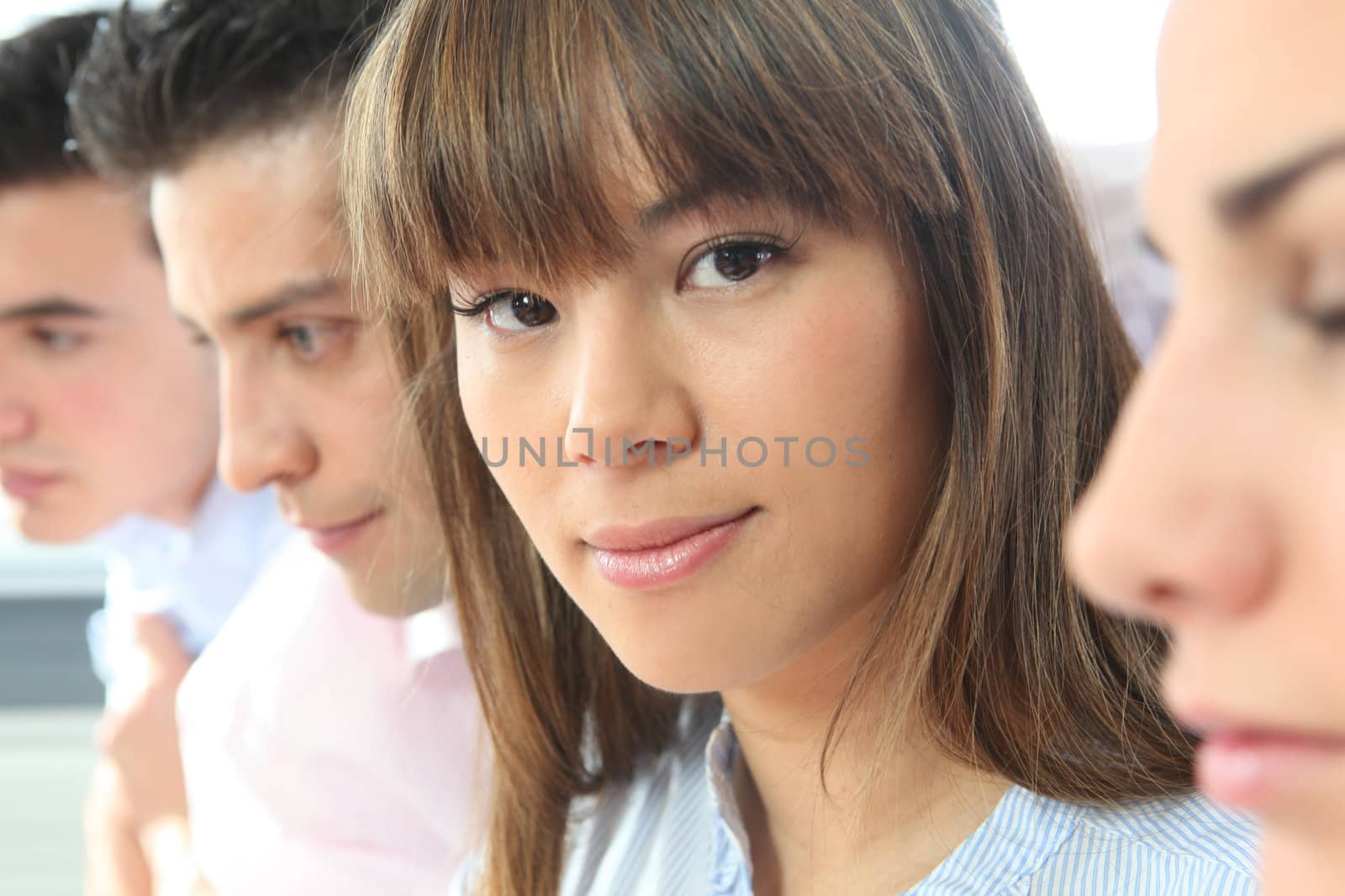 Office worker sat with colleagues