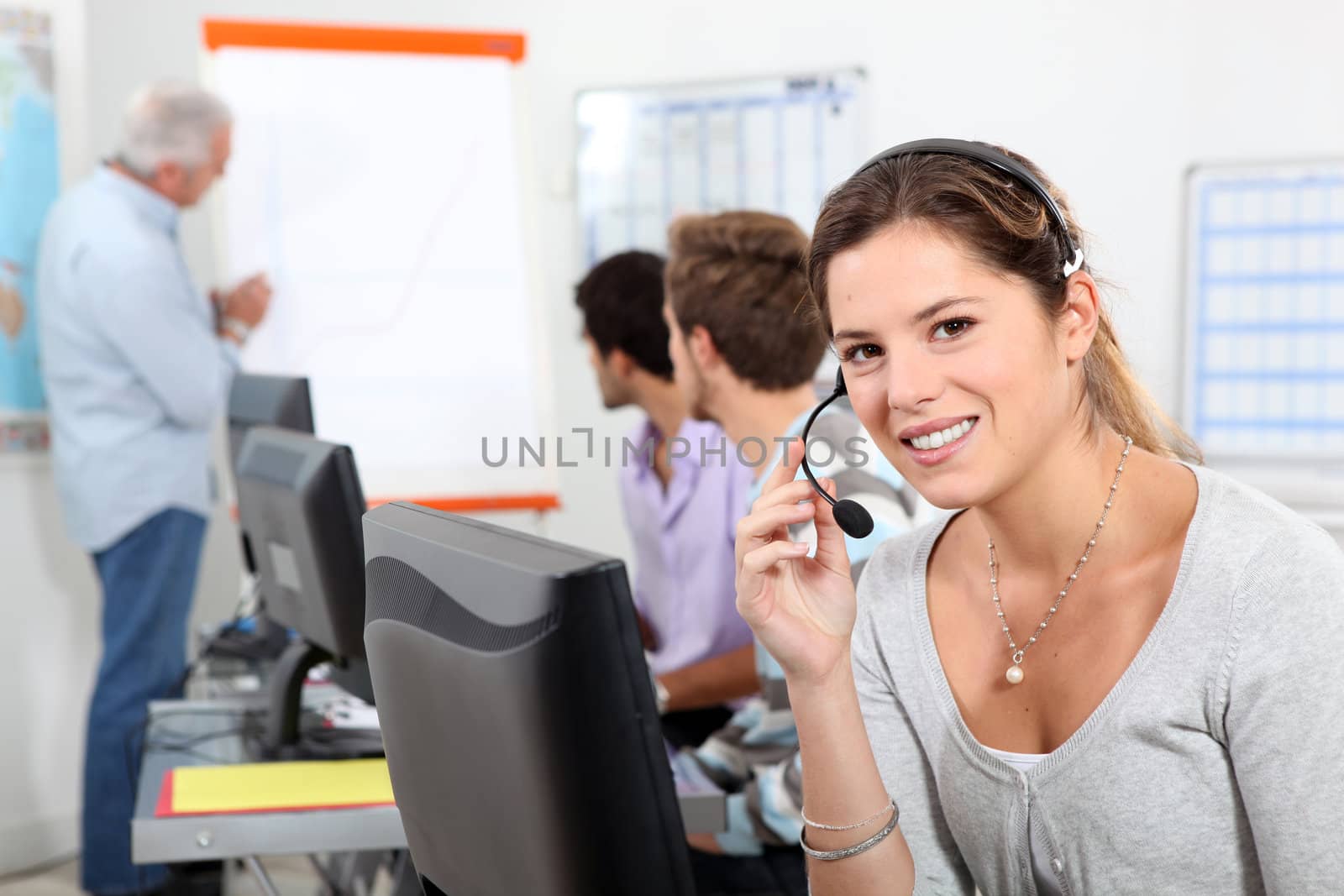 Young woman taking a business call on a headset by phovoir