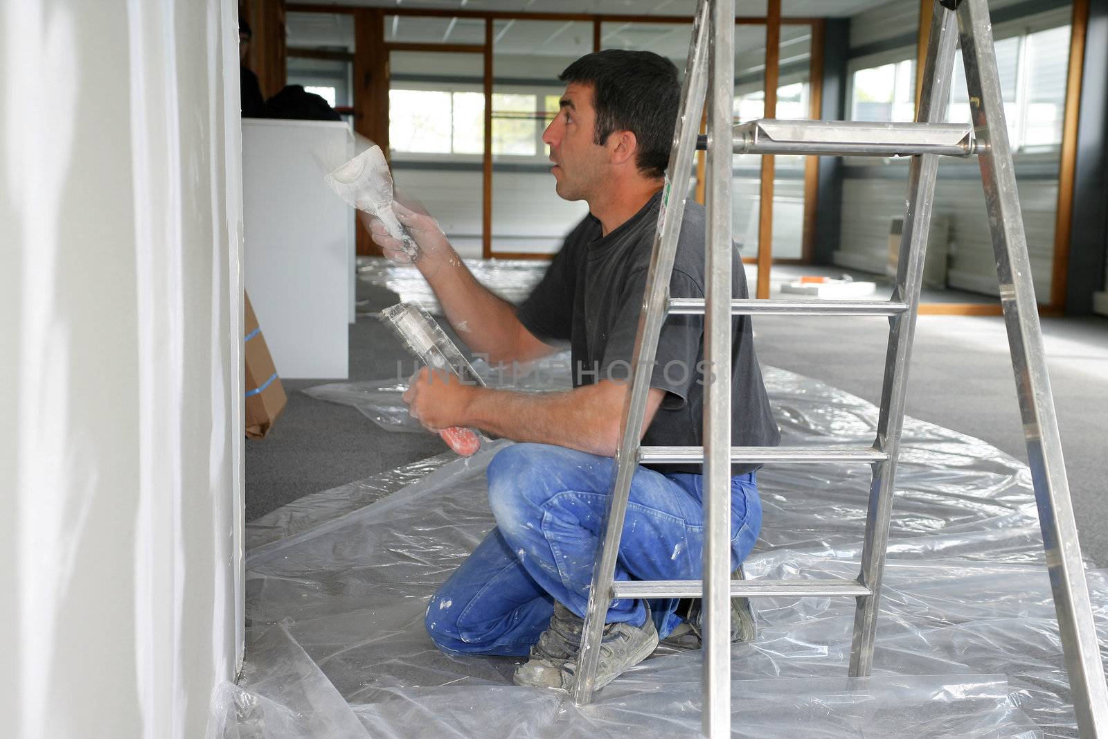 Decorator painting a room