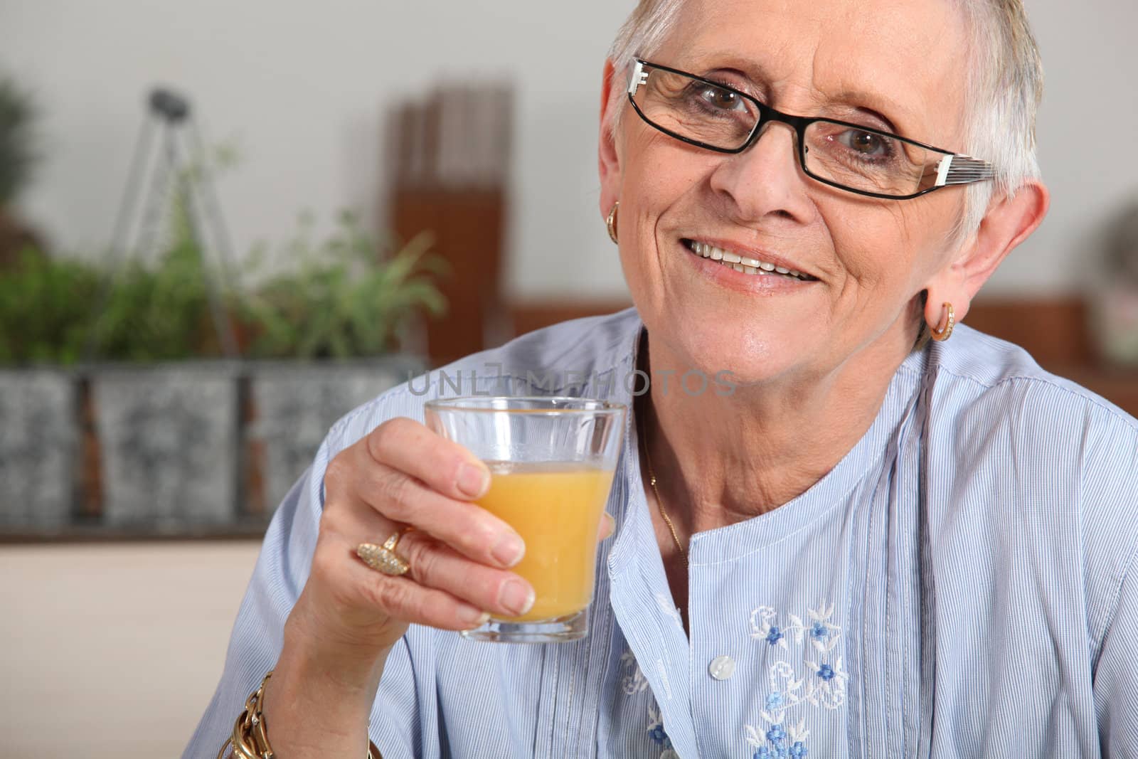 Woman drinking a glass of orange juice