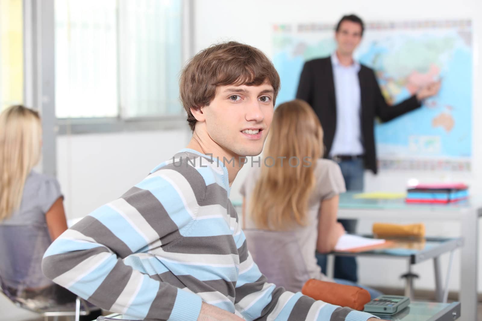 portrait of a young man in classroom by phovoir