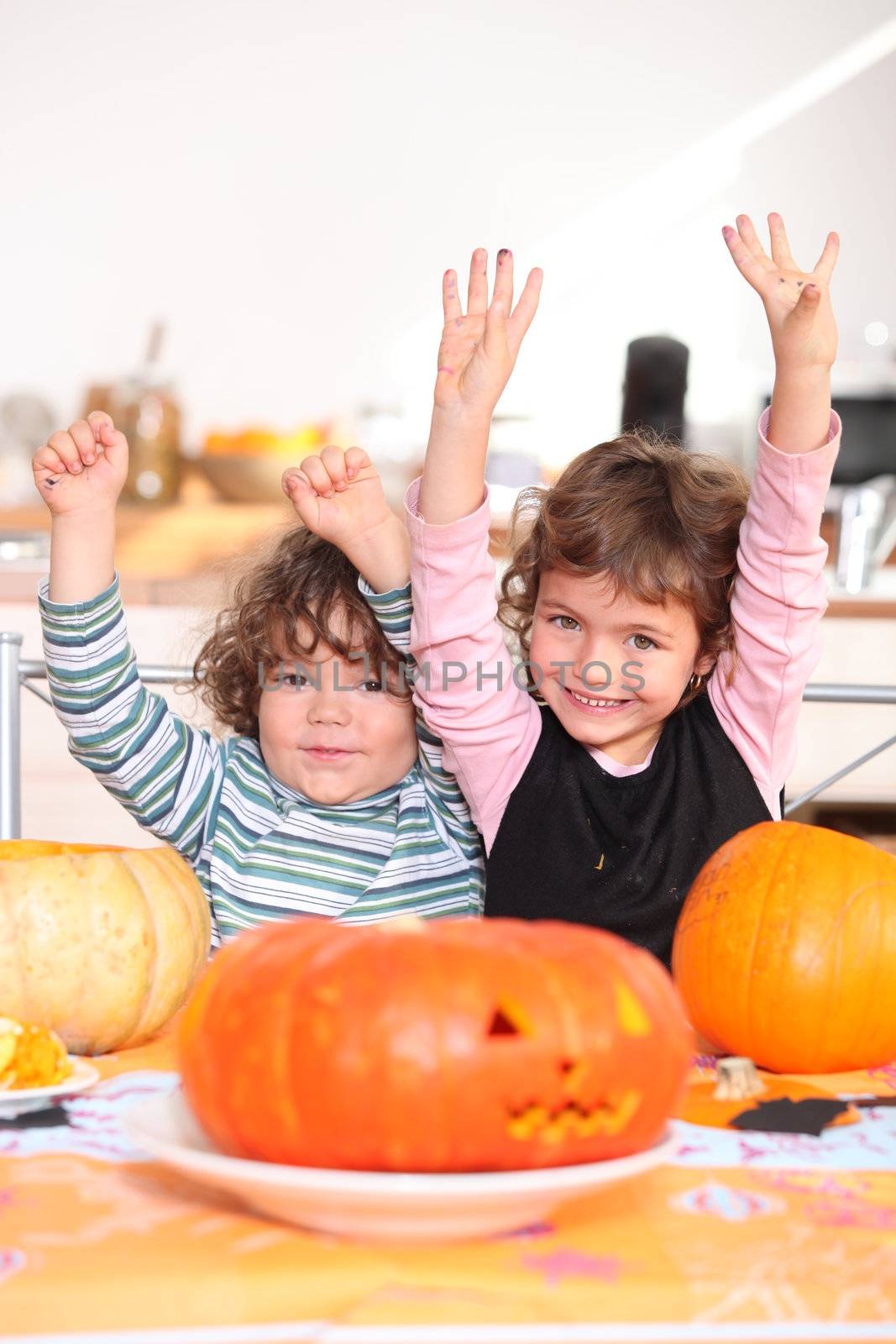 Children carving pumpkins by phovoir