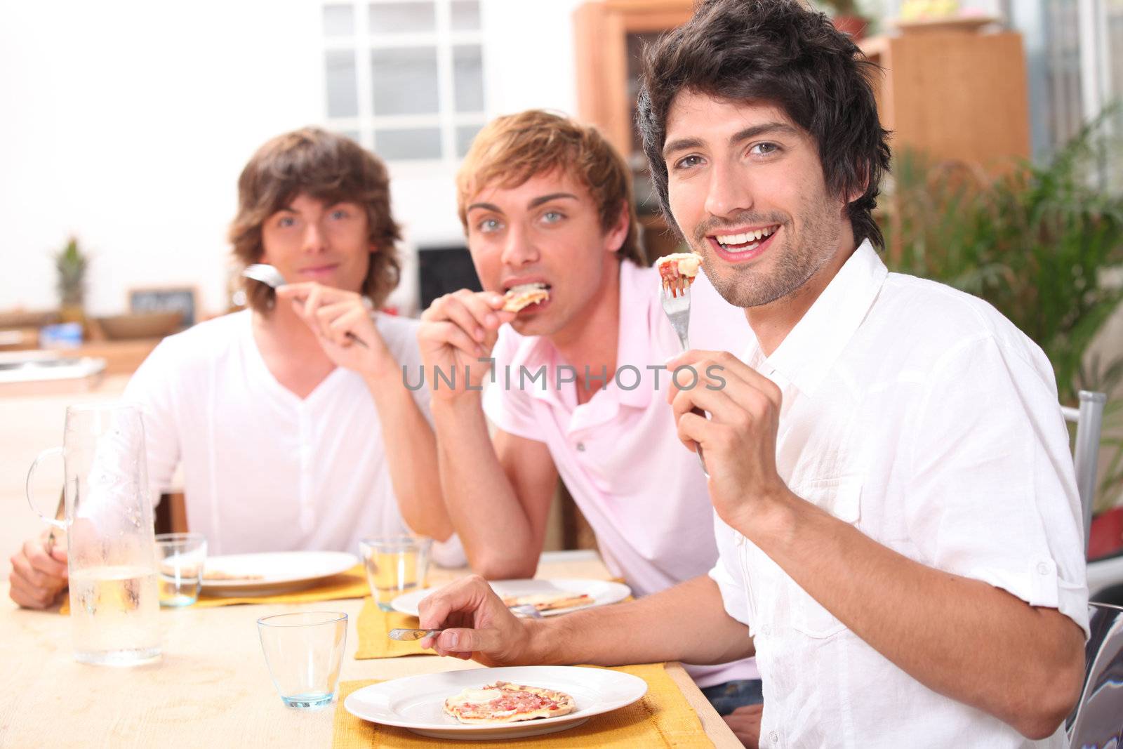 Three friends enjoying outdoor meal together