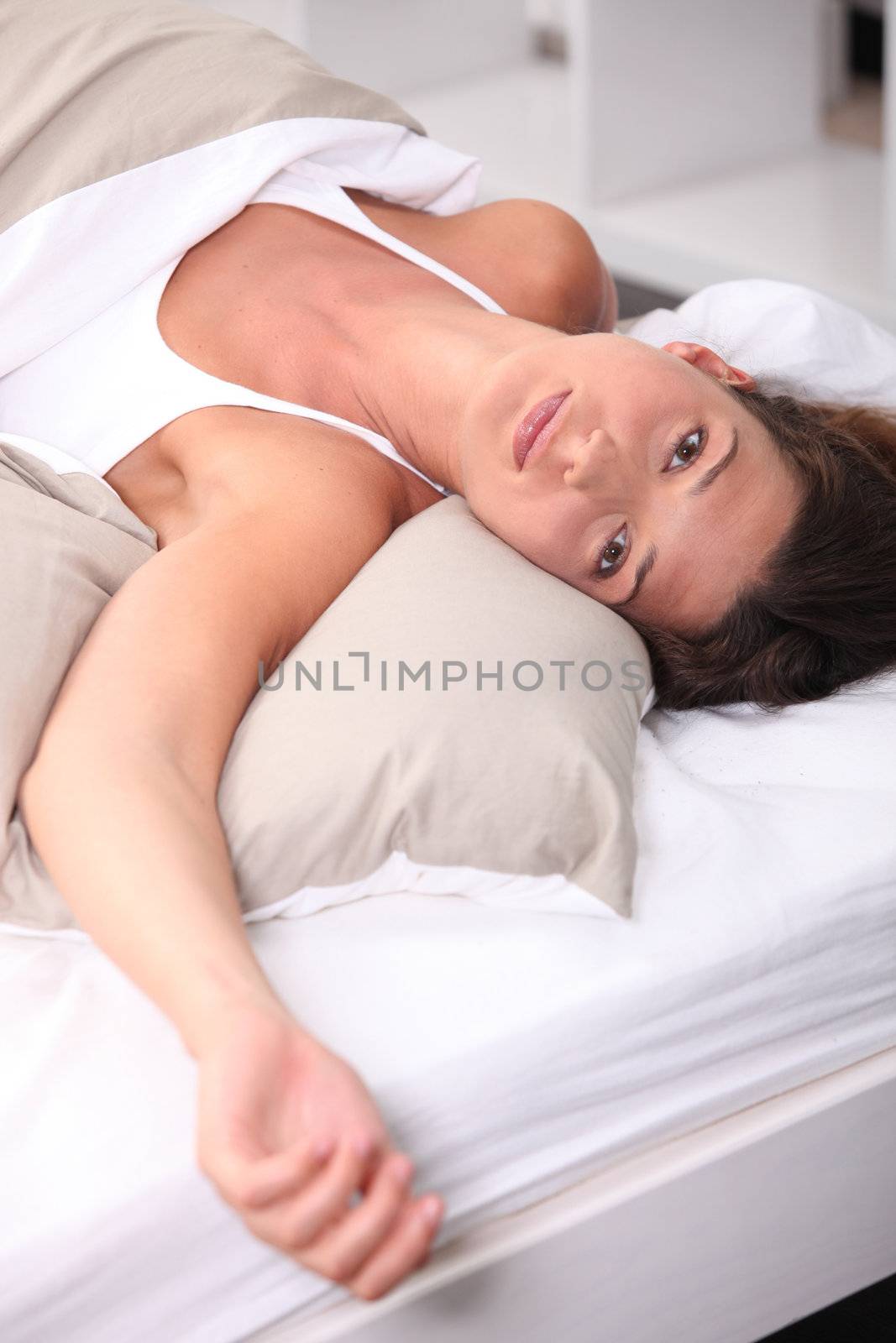 Brunette laying in bed