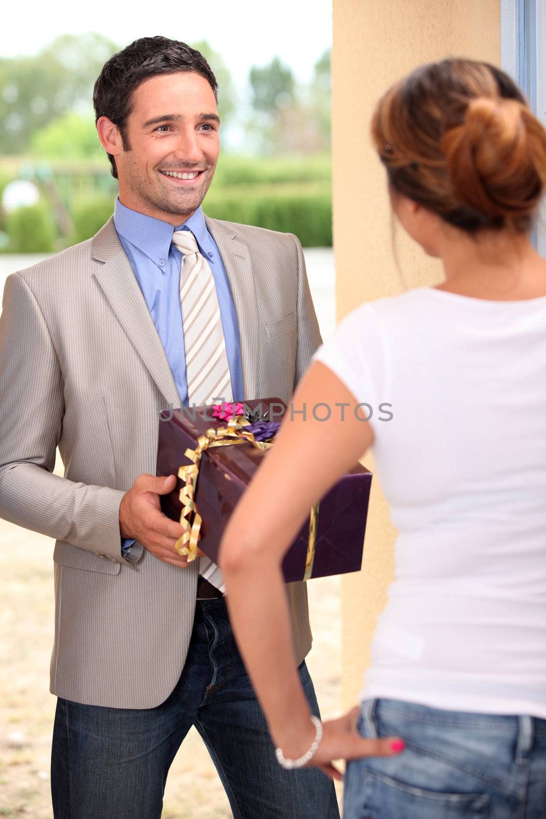 Man giving gift to woman