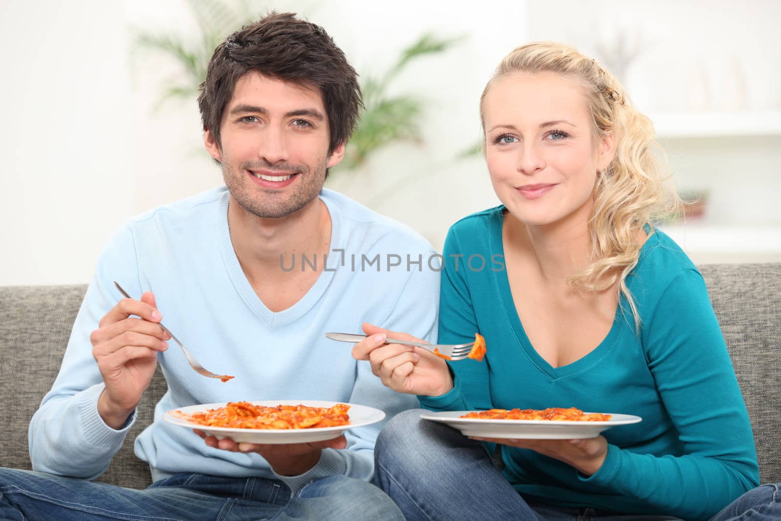 couple having dinner on the couch