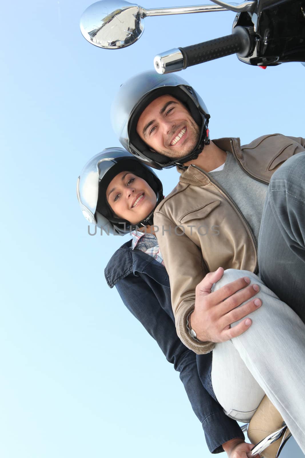 Couple on a scooter in the sunshine