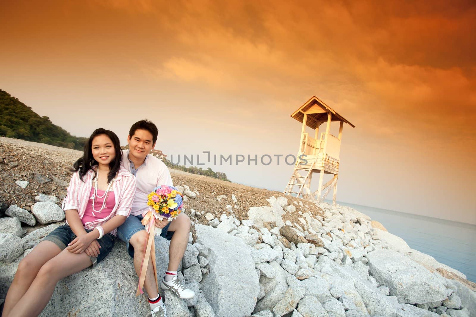 young couples sitting outdoors at the beach