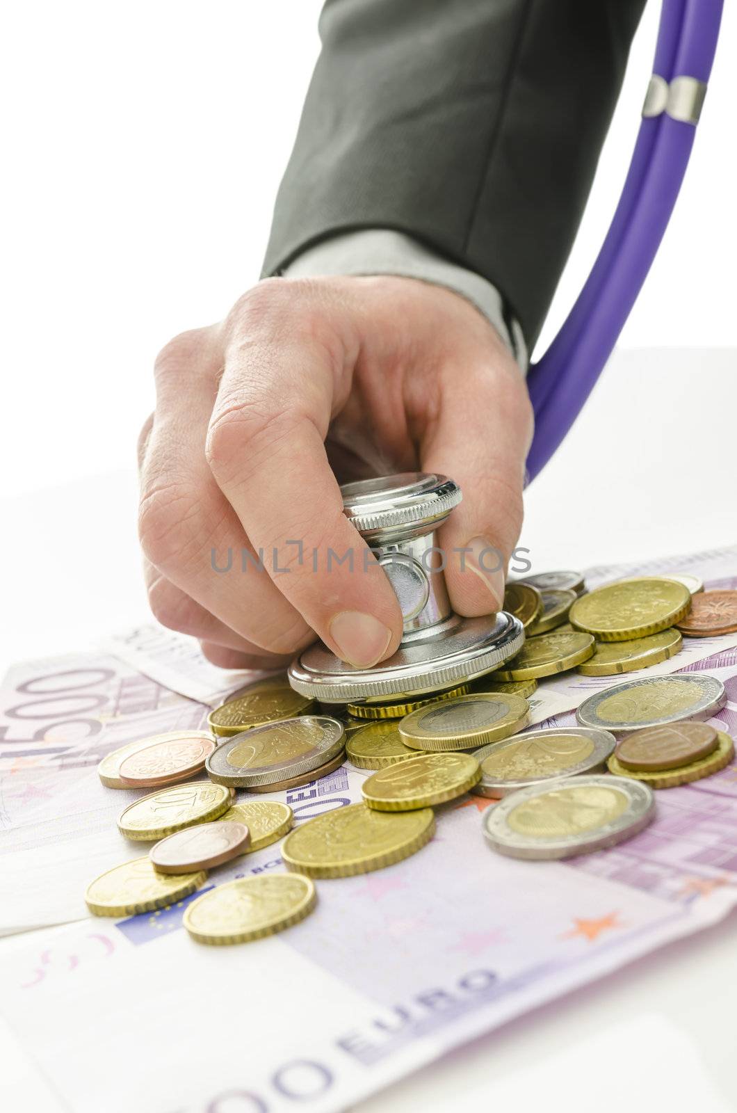 Detail of banker hand holding stethoscope over Euro coins and banknotes. Over white background.