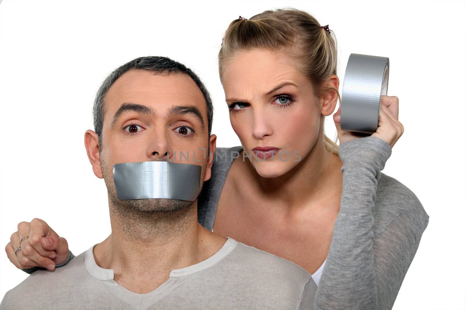 Woman taping-up mans mouth by phovoir