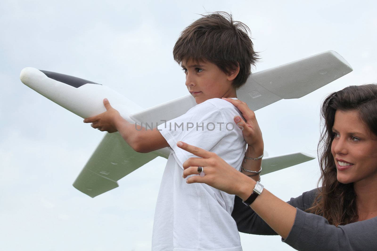 Mother and son playing with a large model toy aeroplane