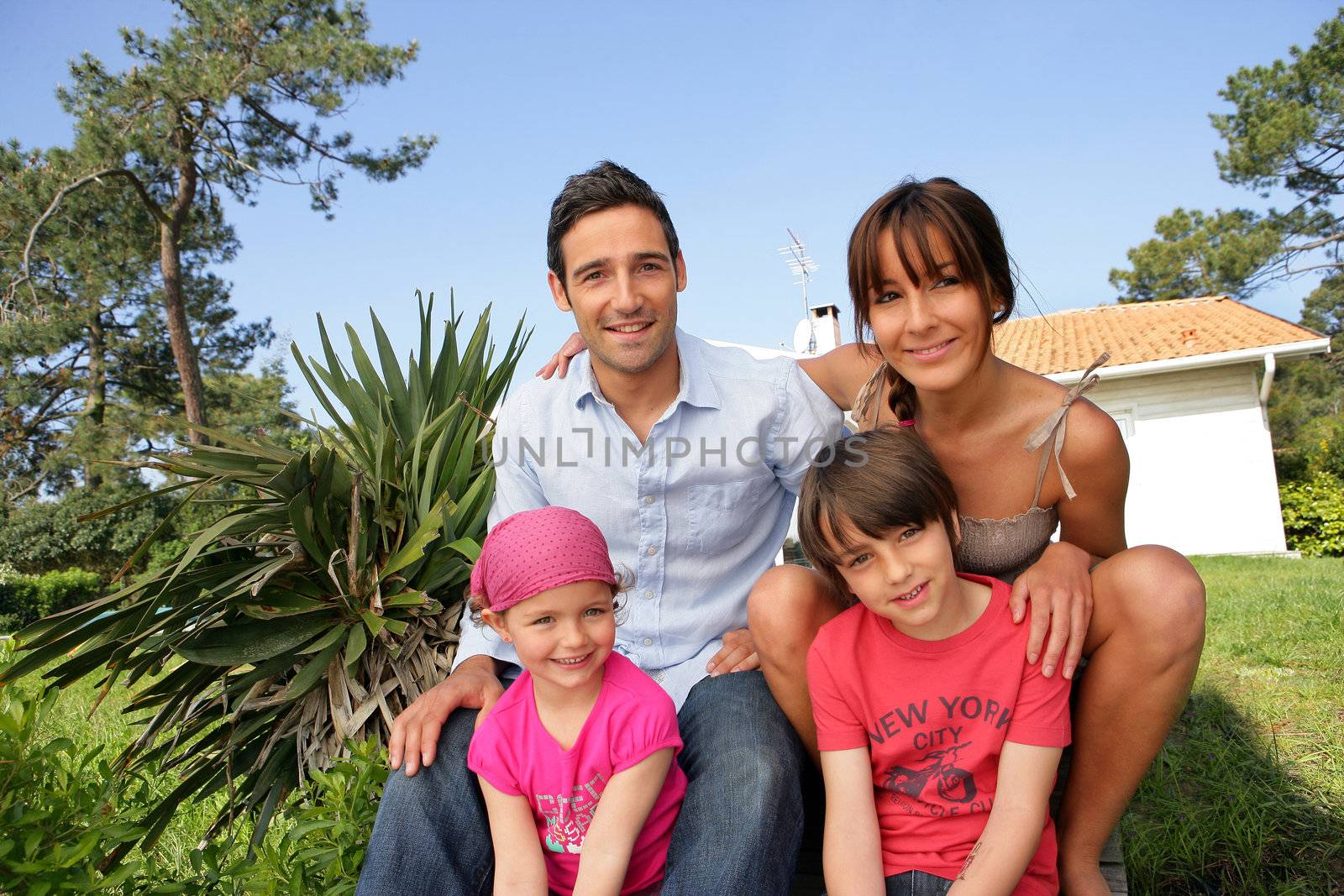 Happy family gathered in the back garden