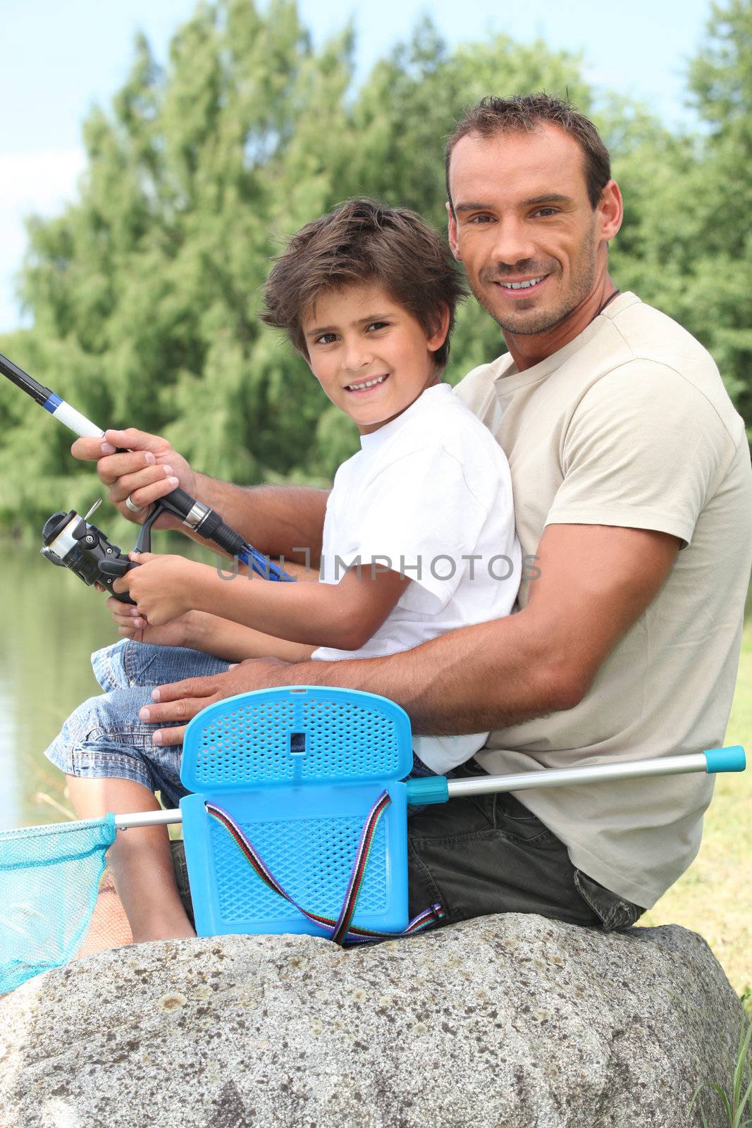 Father and son fishing by phovoir