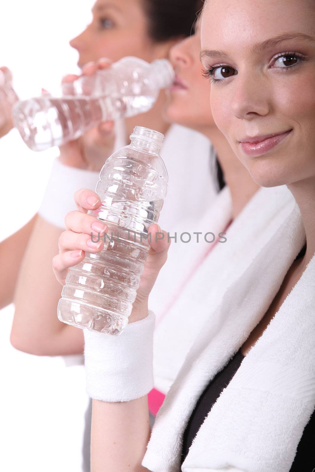 women drinking water after training
