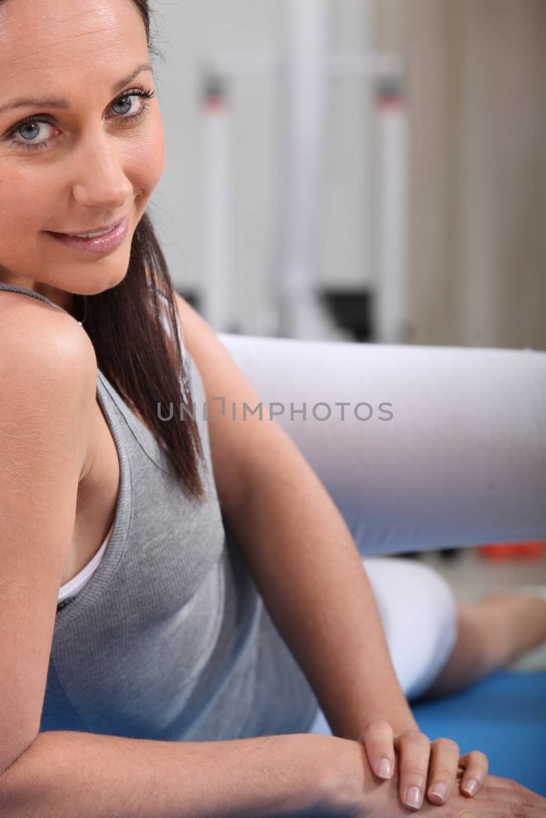 Woman exercising on a mat by phovoir