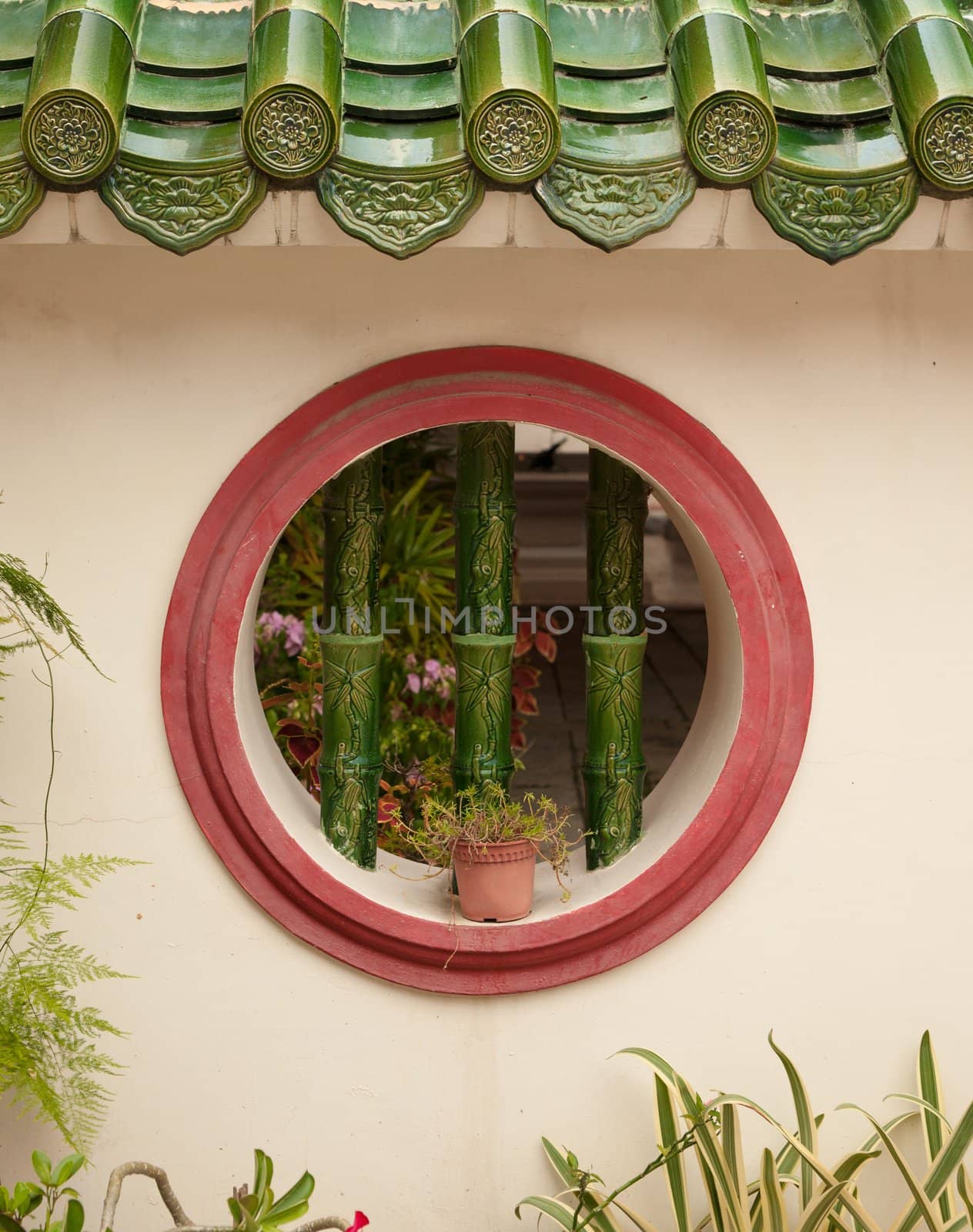 a round barred window in wall background