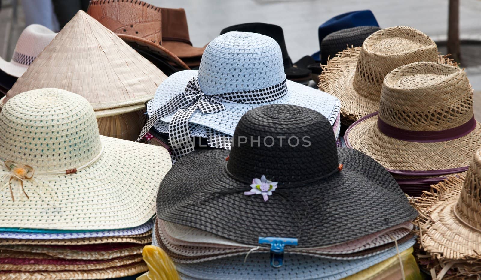lots of hats for sale in market focus is on blue hat