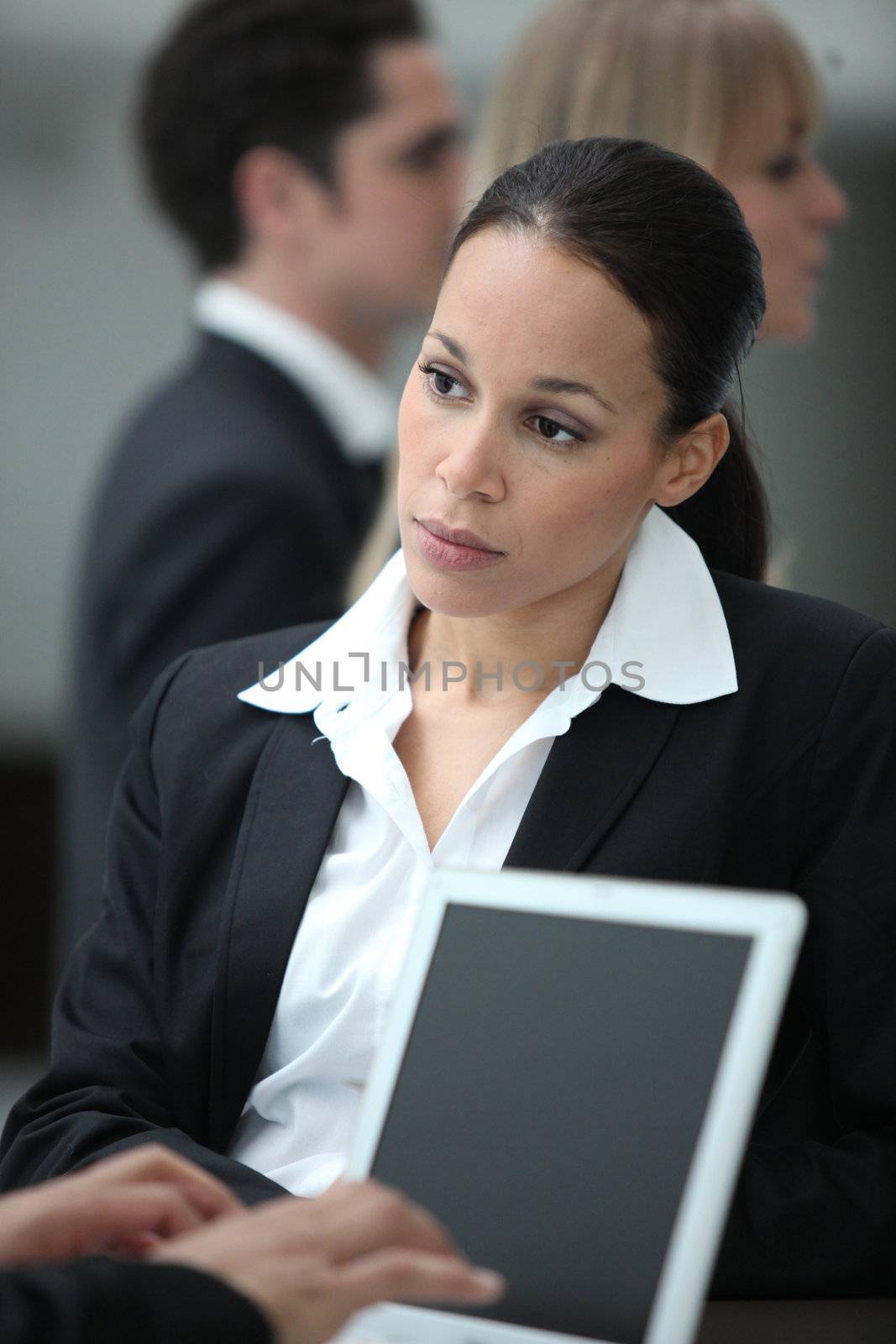 Female executive working with colleague at a laptop