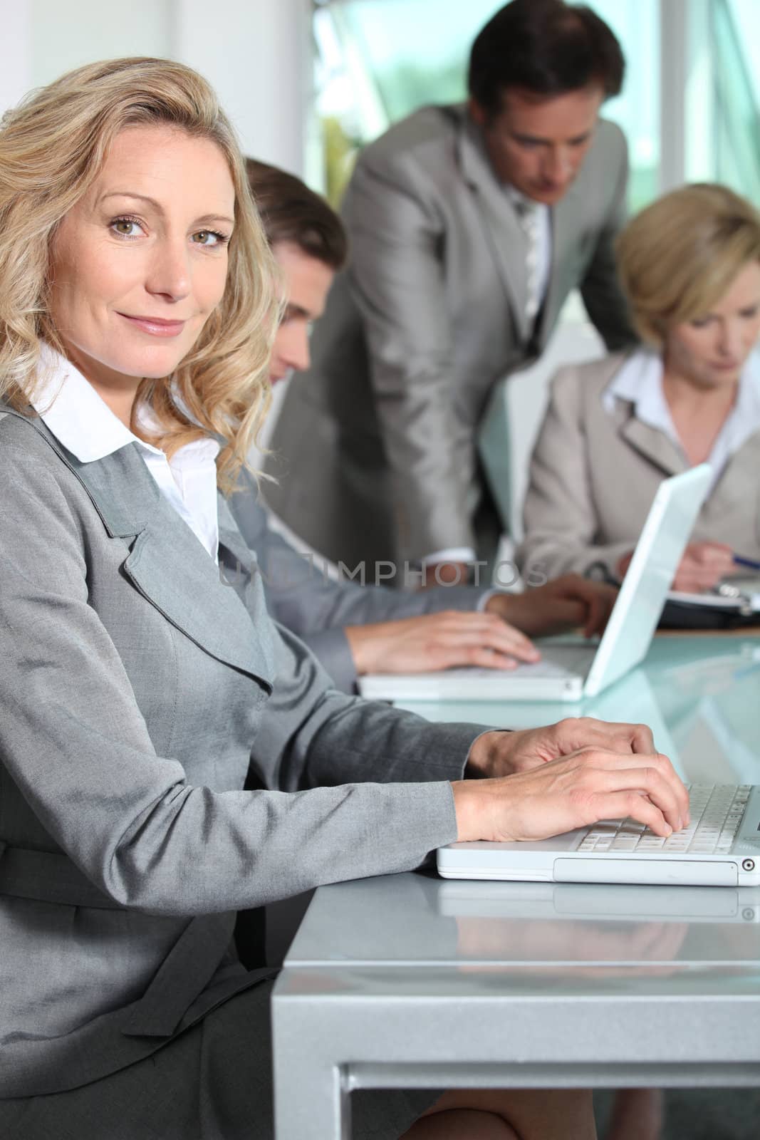 Businesswoman on laptop smiling