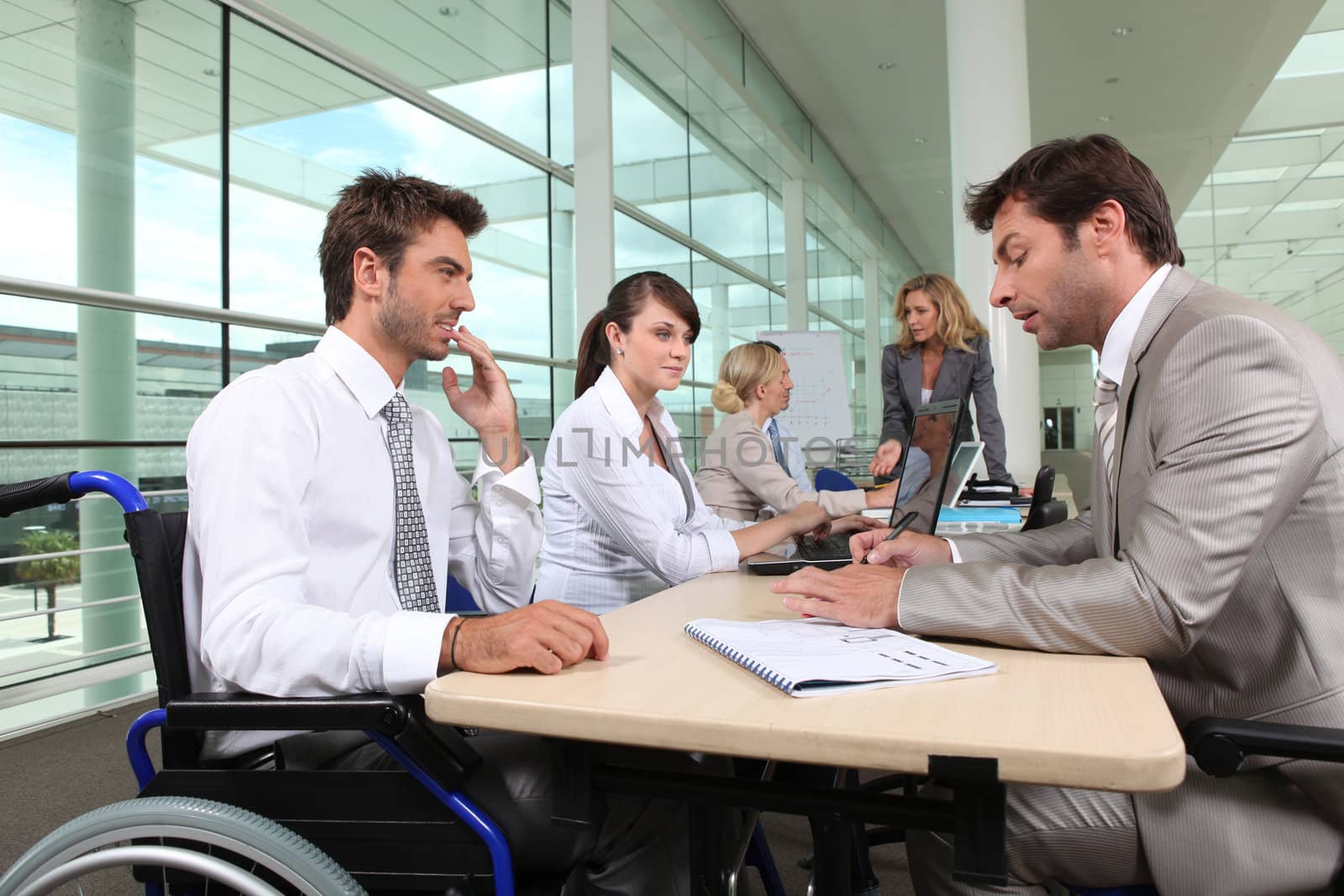 Man in wheelchair working in an office