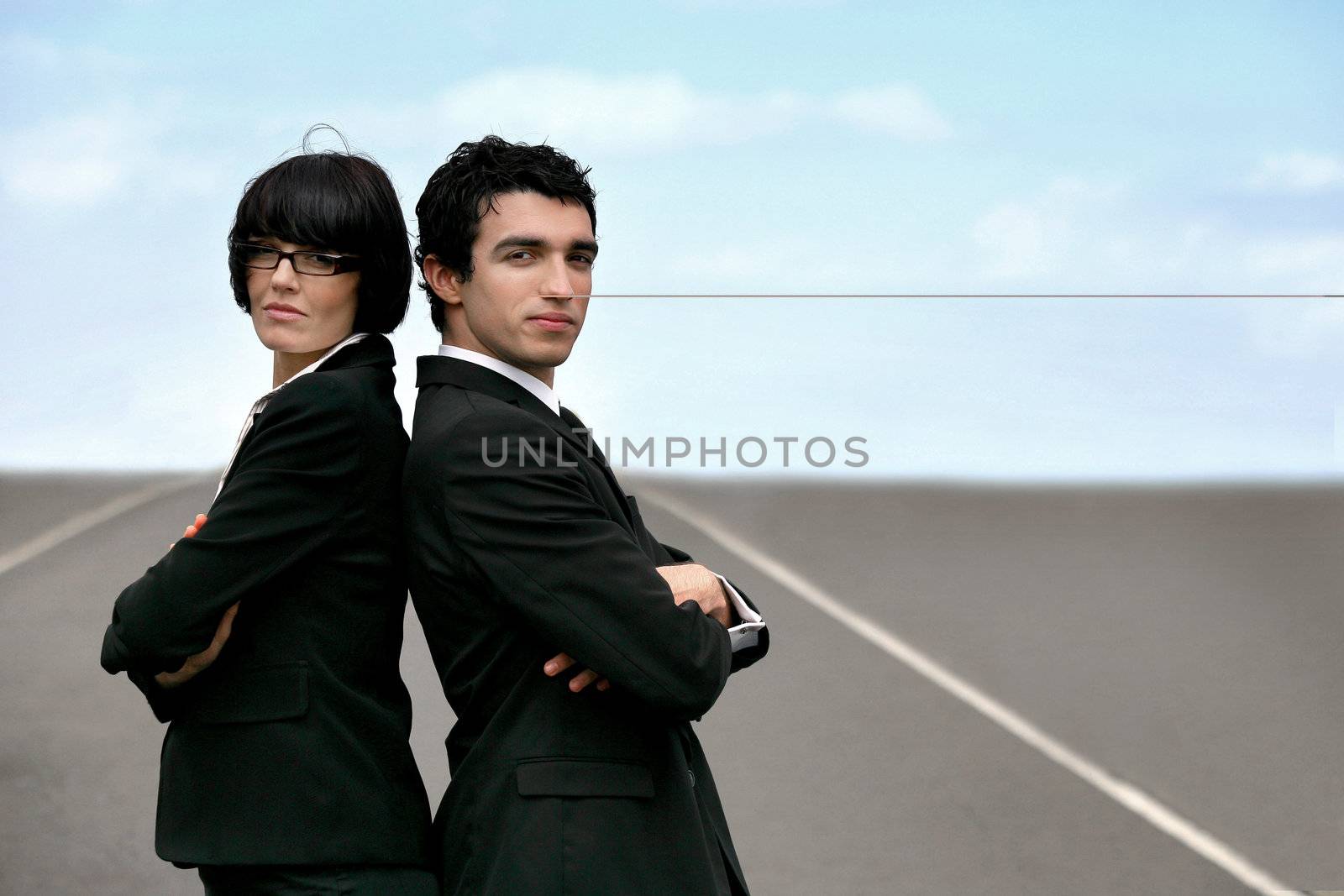 Two businesspeople stood on runway