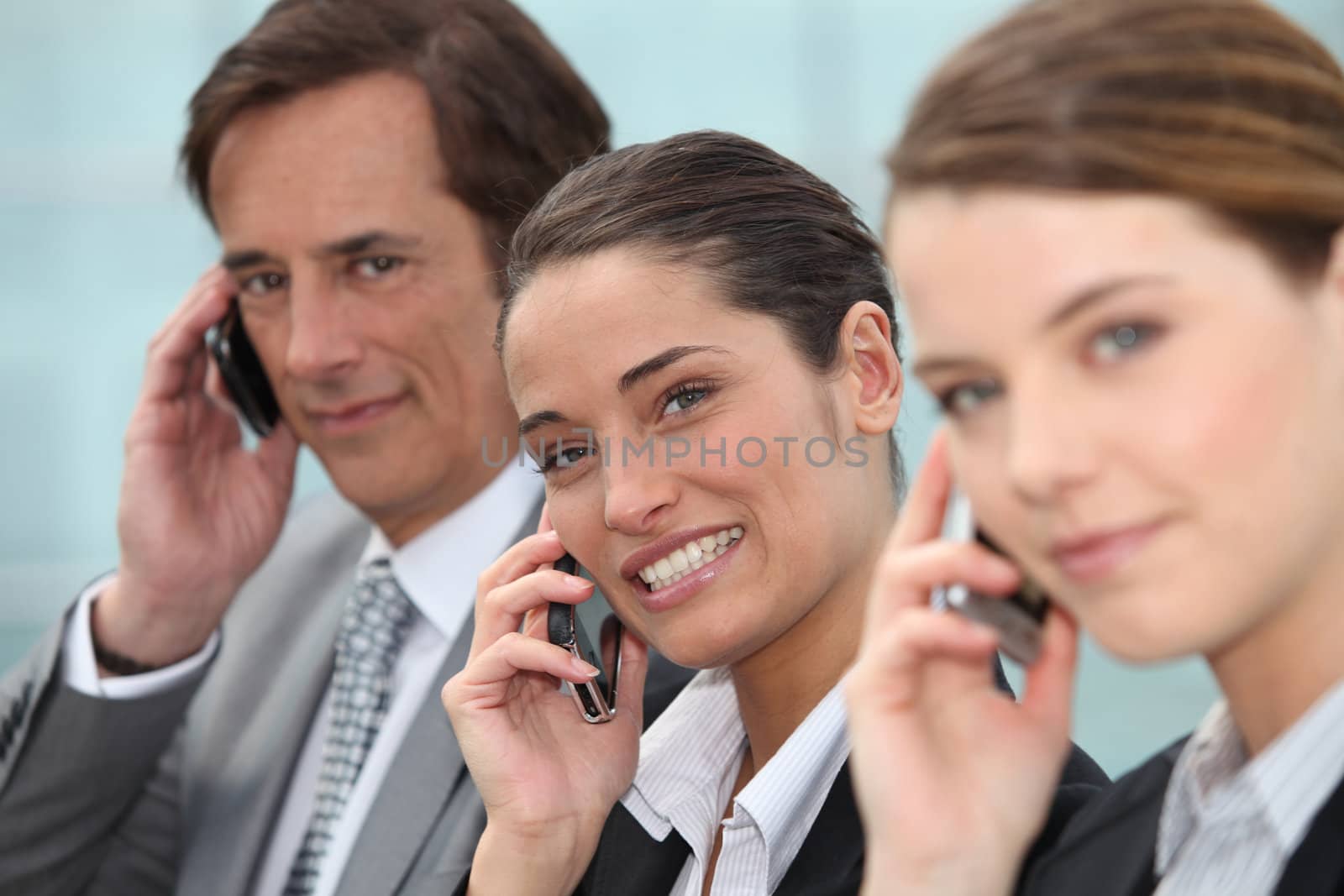 Three businesspeople on phone