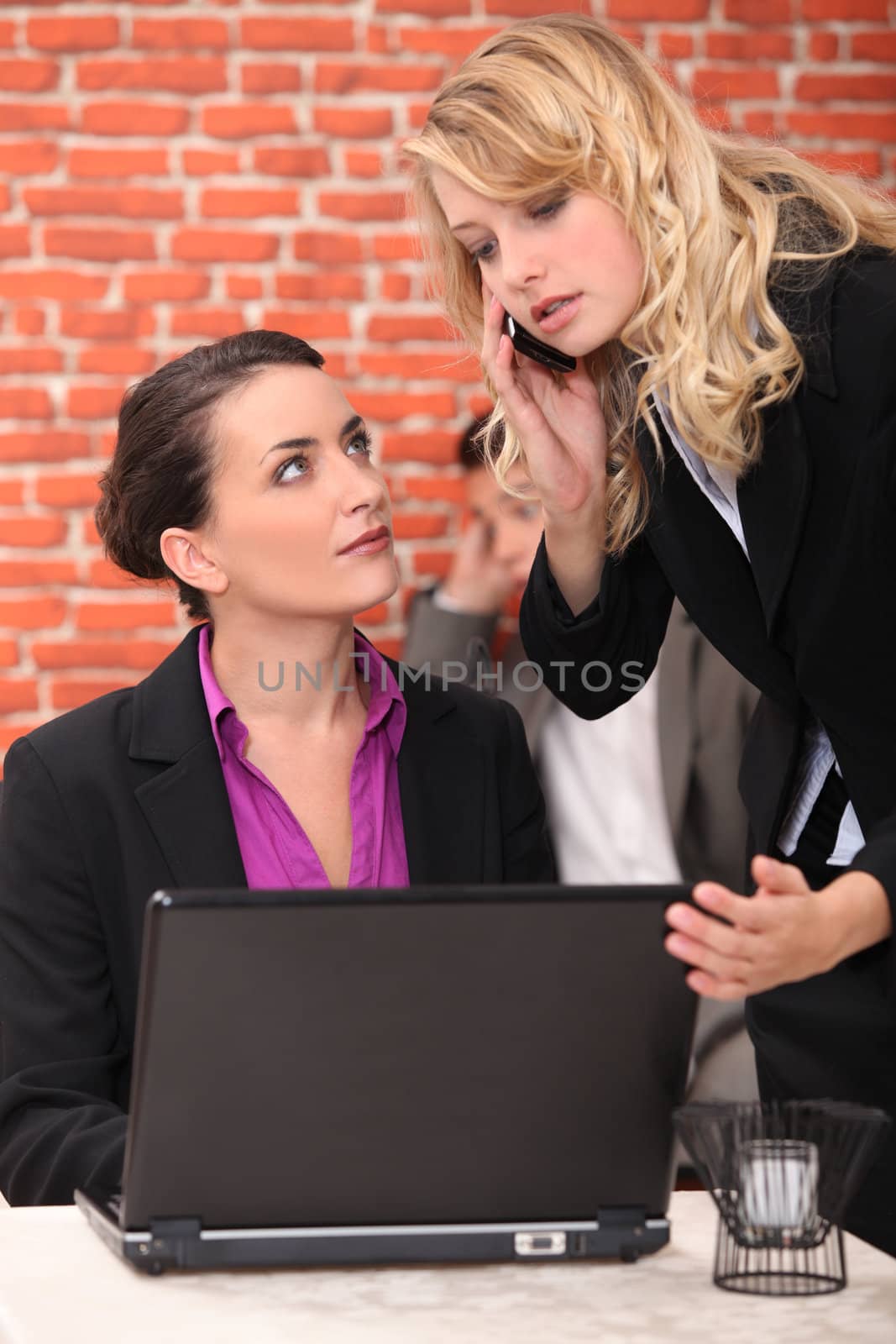 Restaurant owner using a laptop and taking a call by phovoir