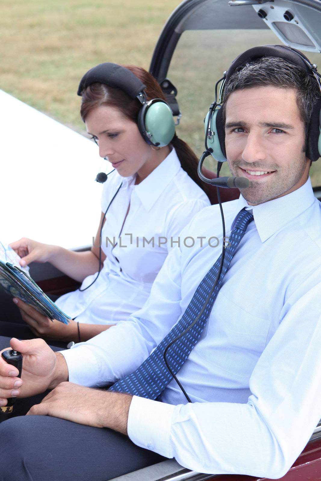 Couple sitting in the cockpit of a light aircraft