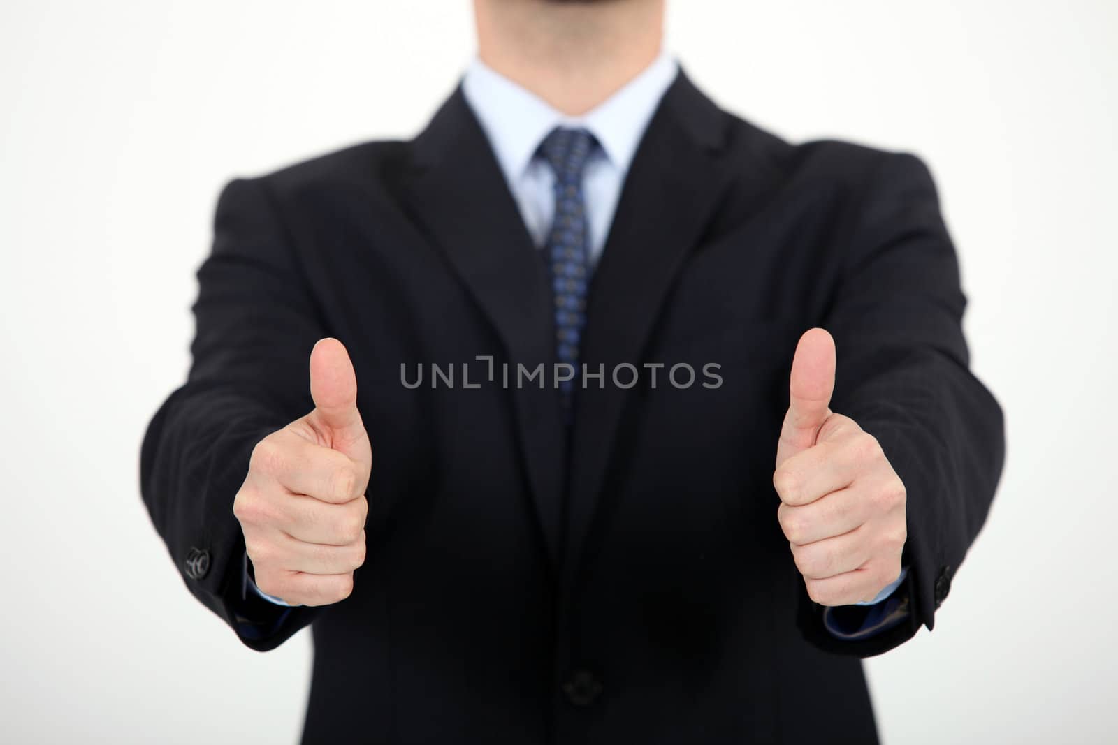 Businessman giving thumbs-up by phovoir