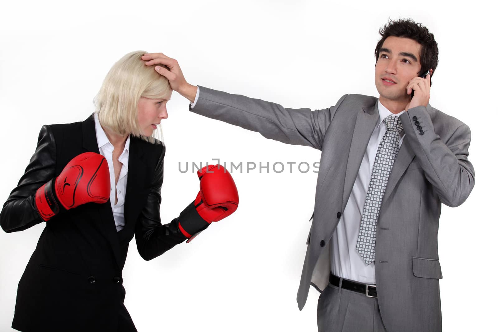 Businesswoman boxing a man on the phone