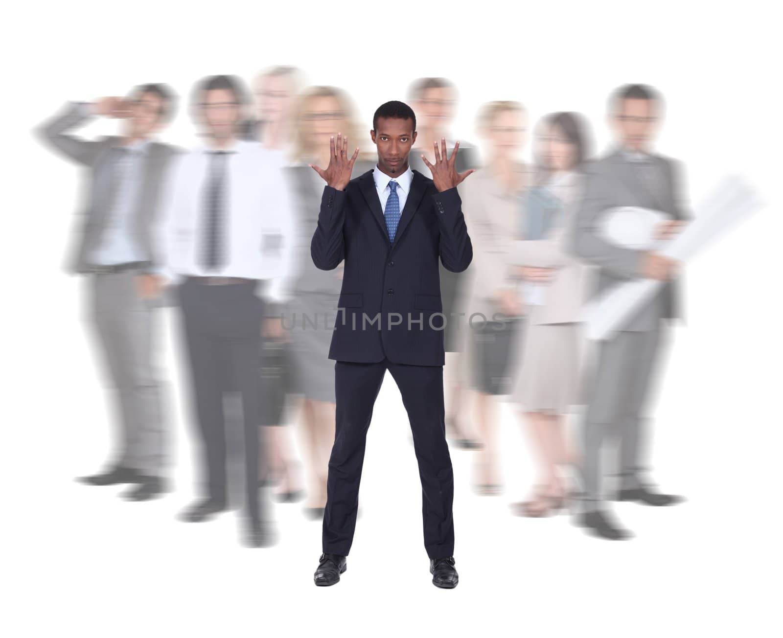 Businessman stood in front of blurred colleagues by phovoir