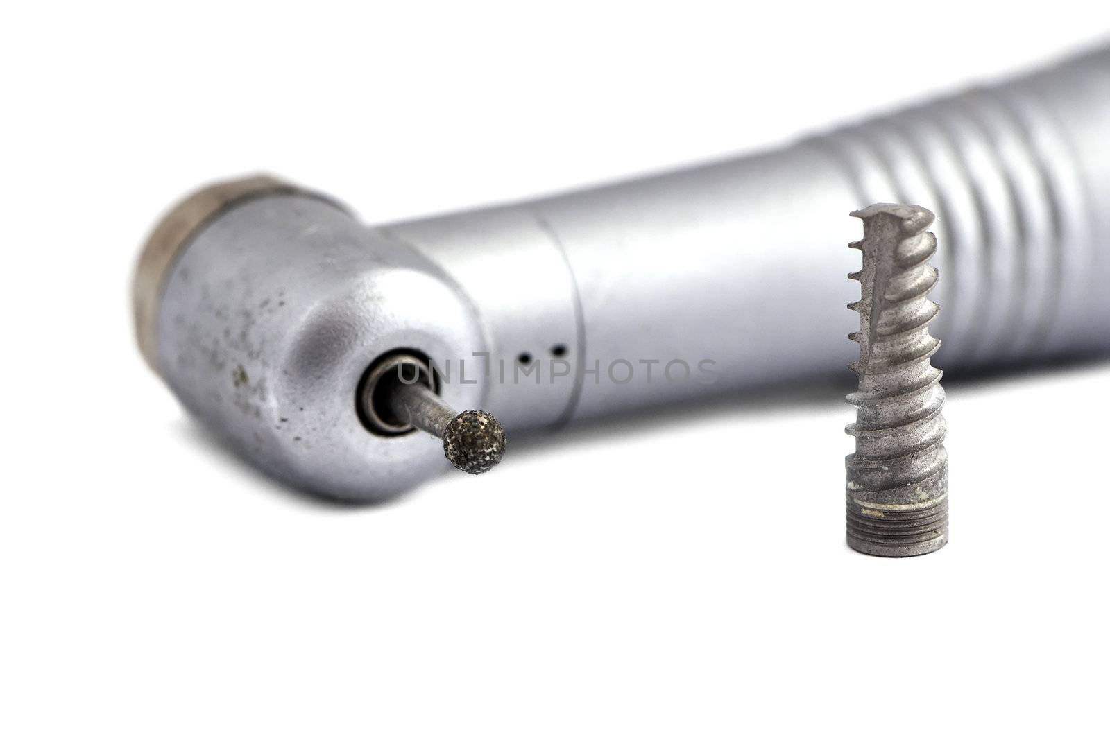 dental handpiece and  implant on a white background