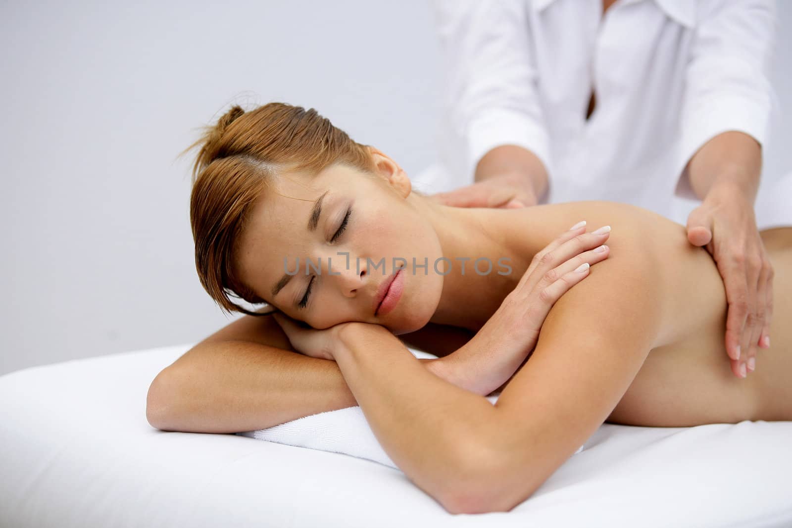 Gorgeous woman having a back massage by phovoir