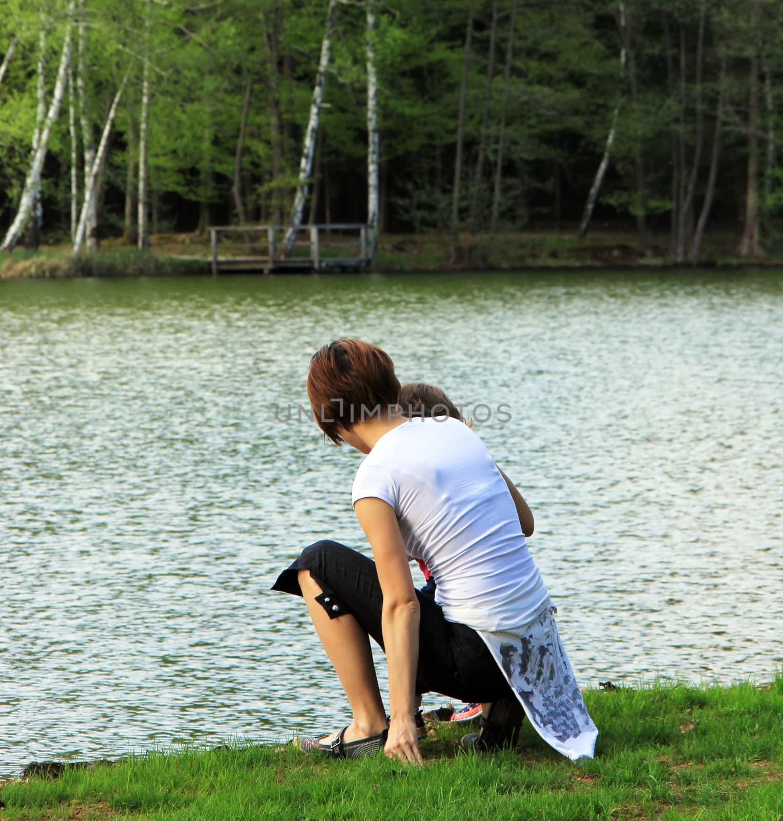 Young and happy family having fun in the park, relaxing, enjoying in beautiful early spring nature.