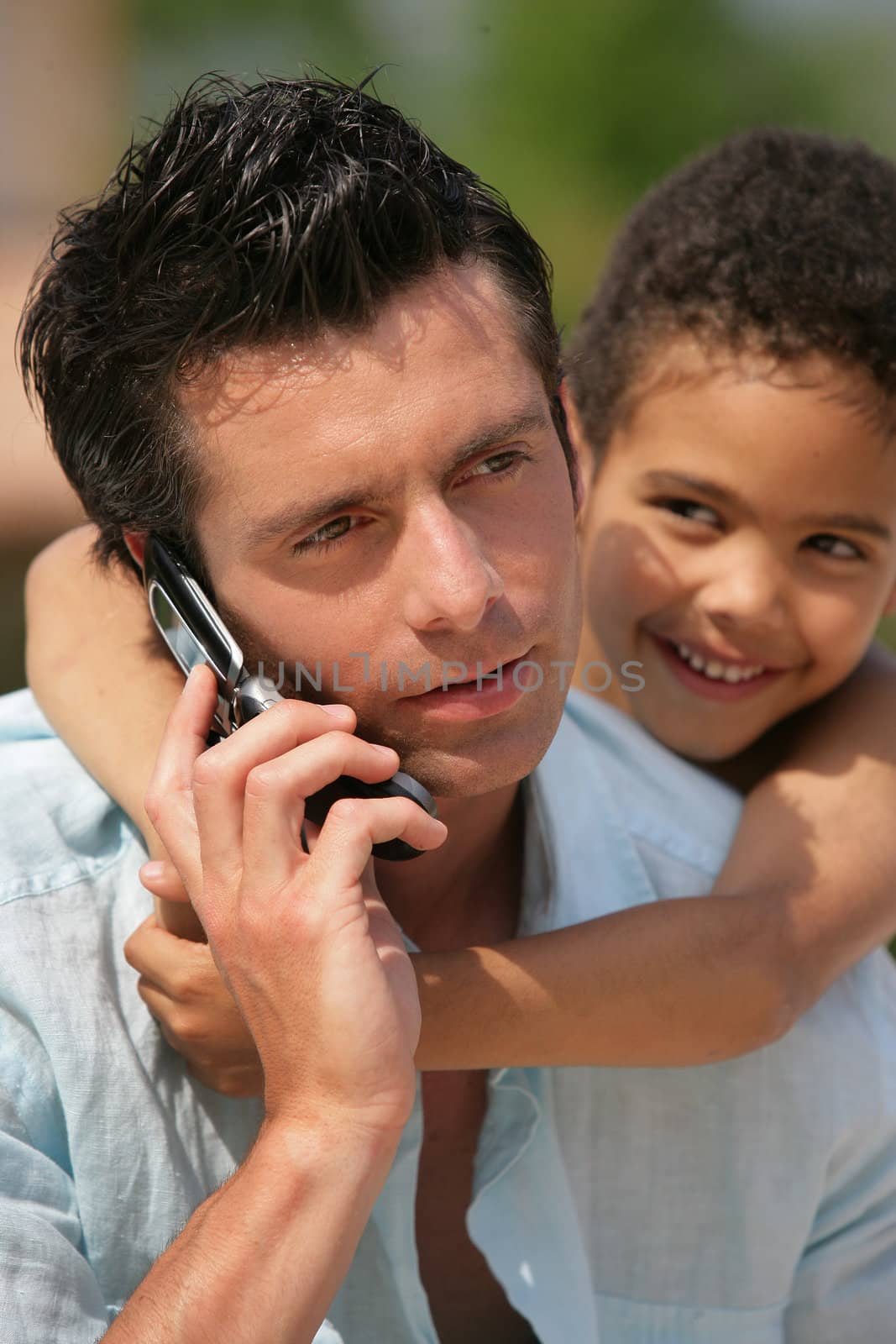 man on phone with little metis boy