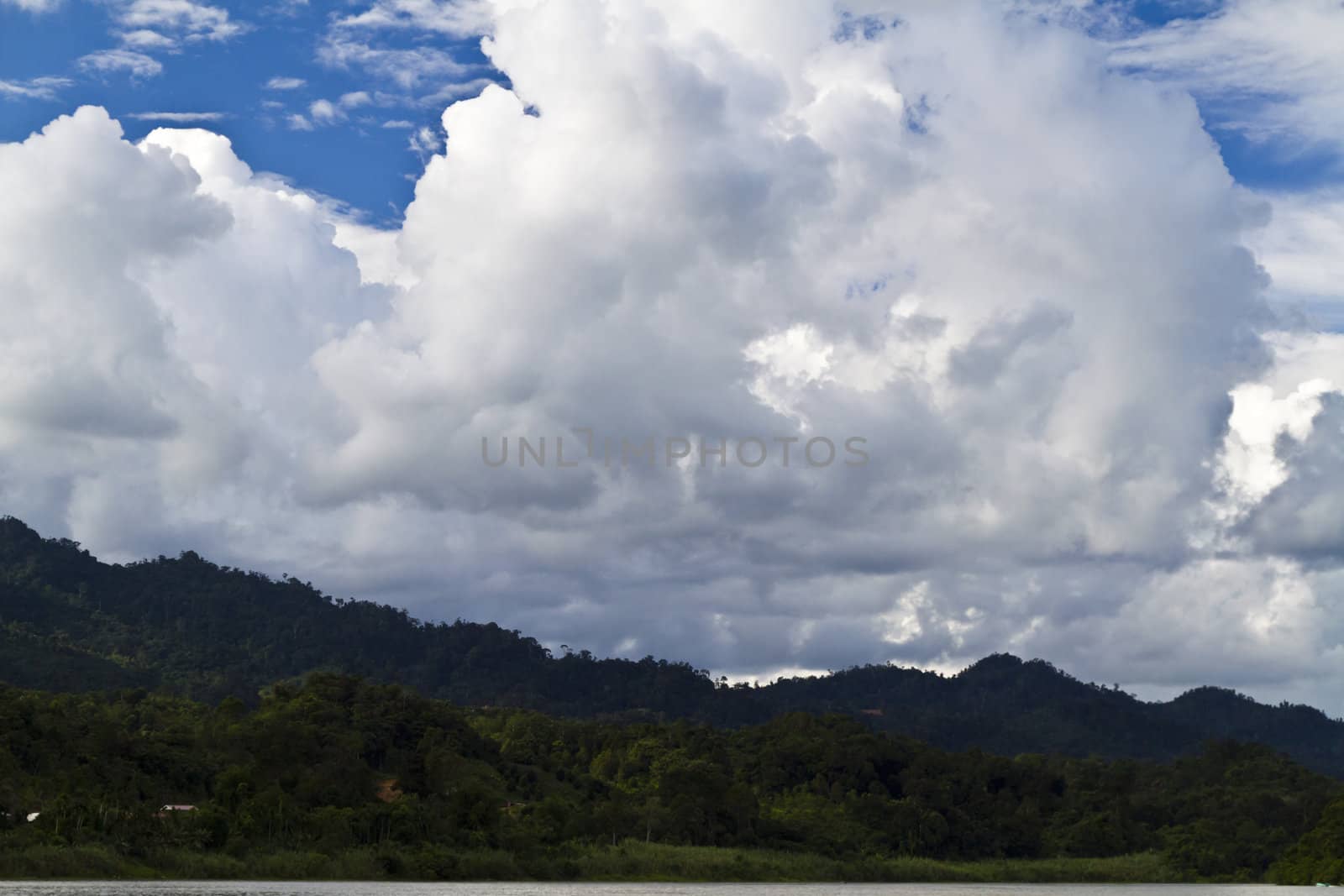 view of highlands from Rajang River in Sarawak, Malaysia with clouds forming in the background