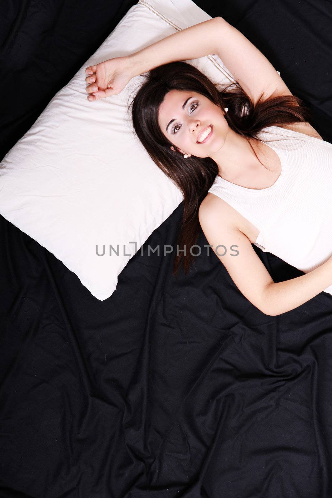 A young hispanic Woman sleeping on the Bed.