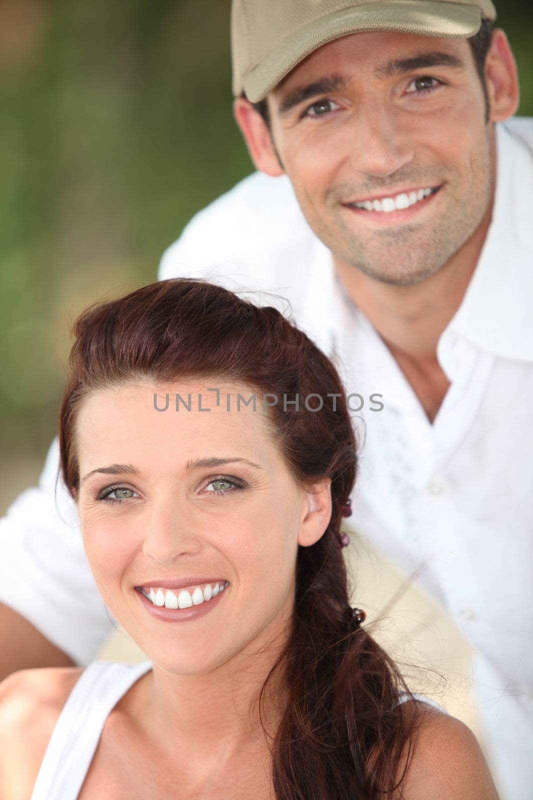 Smiling couple outdoors by phovoir