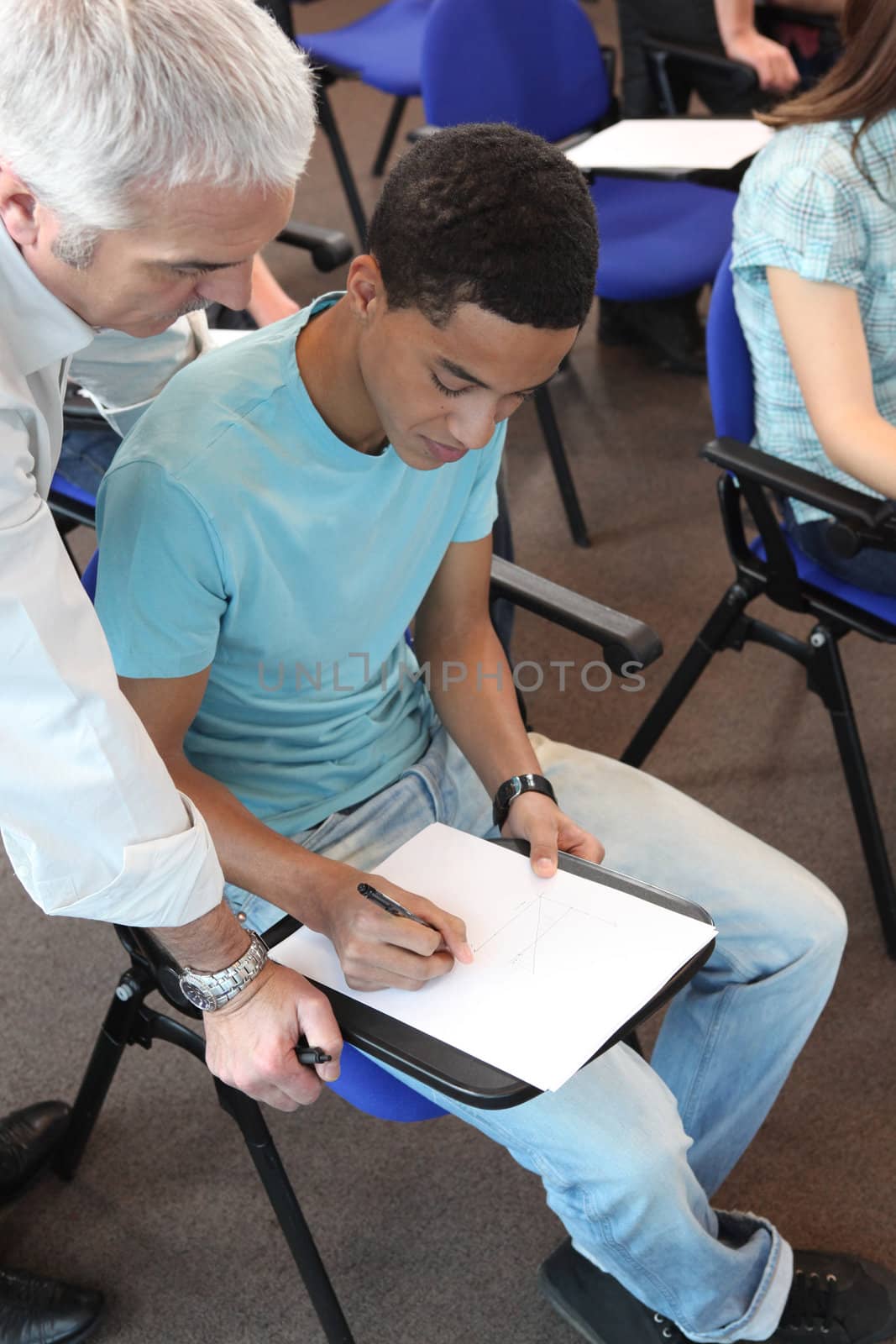 Young man in professional training with teacher