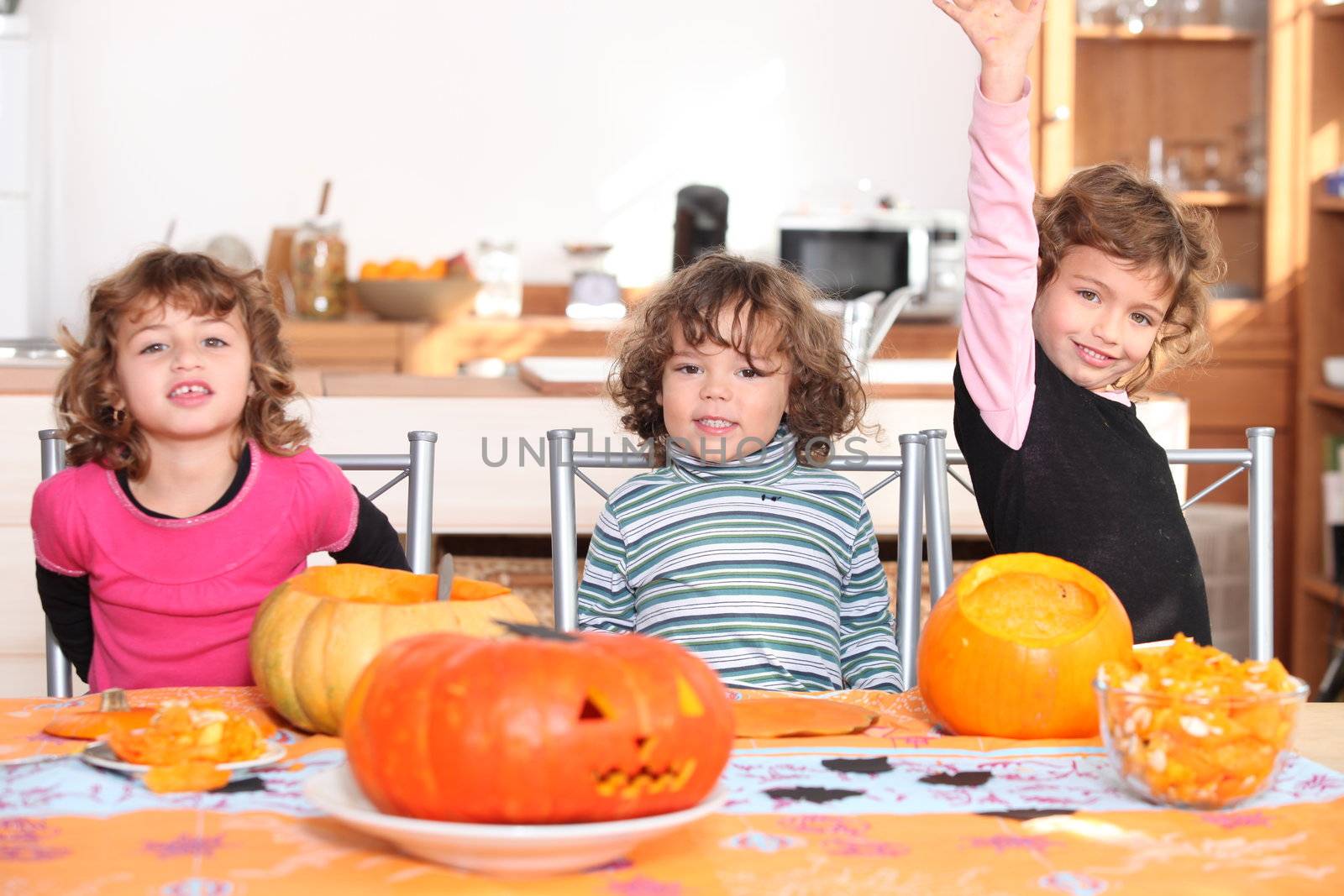 Kids preparing pumpkins for Halloween by phovoir