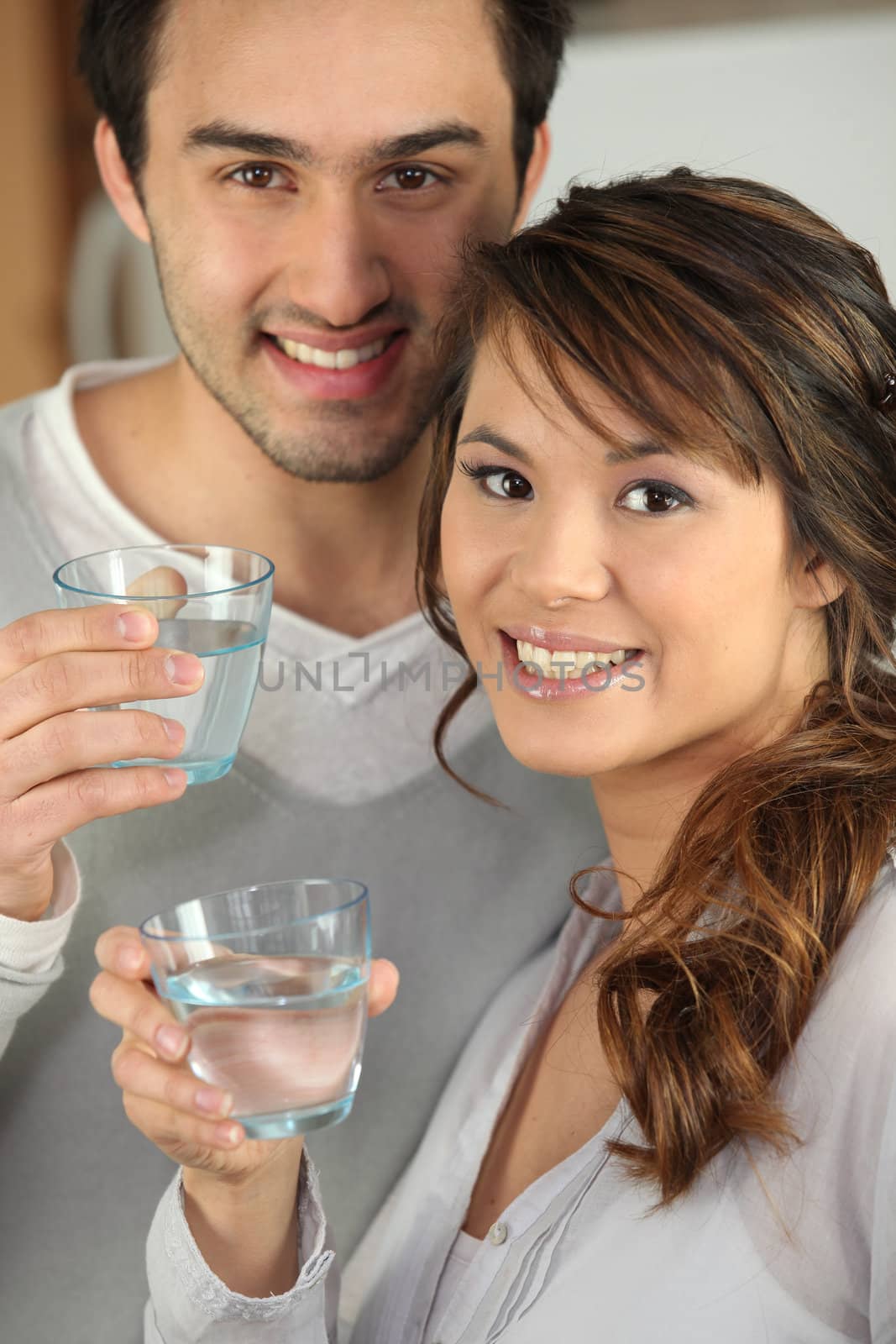 Couple drinking glasses of water