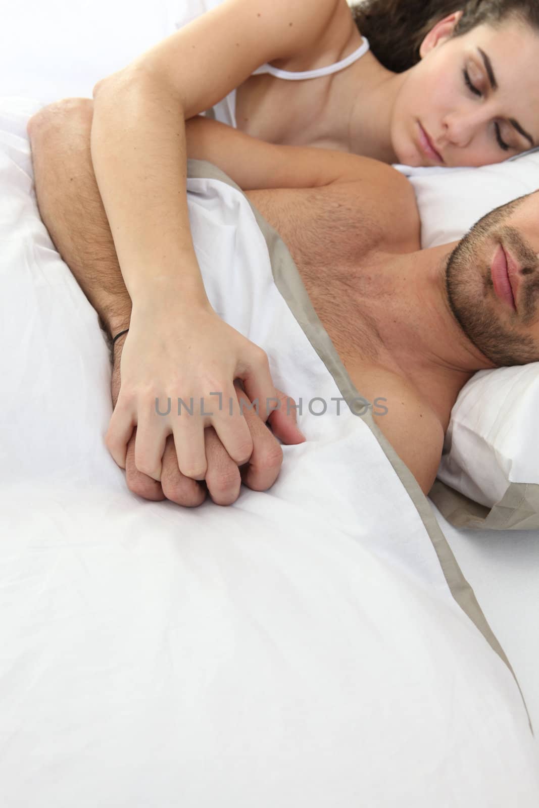 Couple sleeping in bed by phovoir