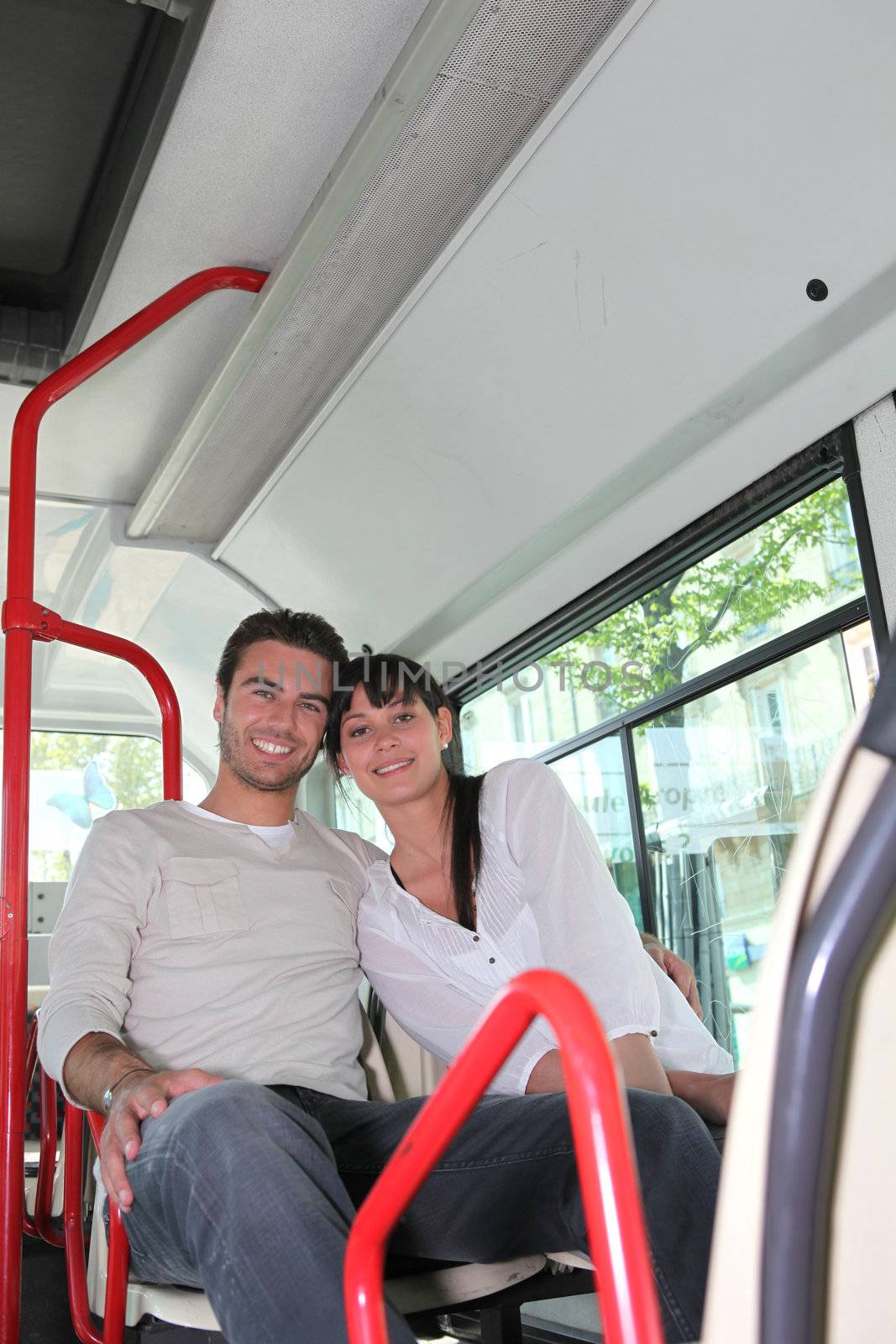Couple sat on the bus by phovoir