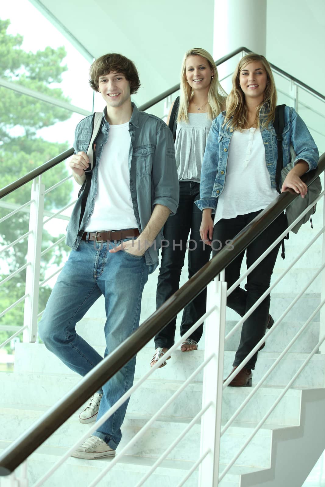 Three teenagers walking down stairs