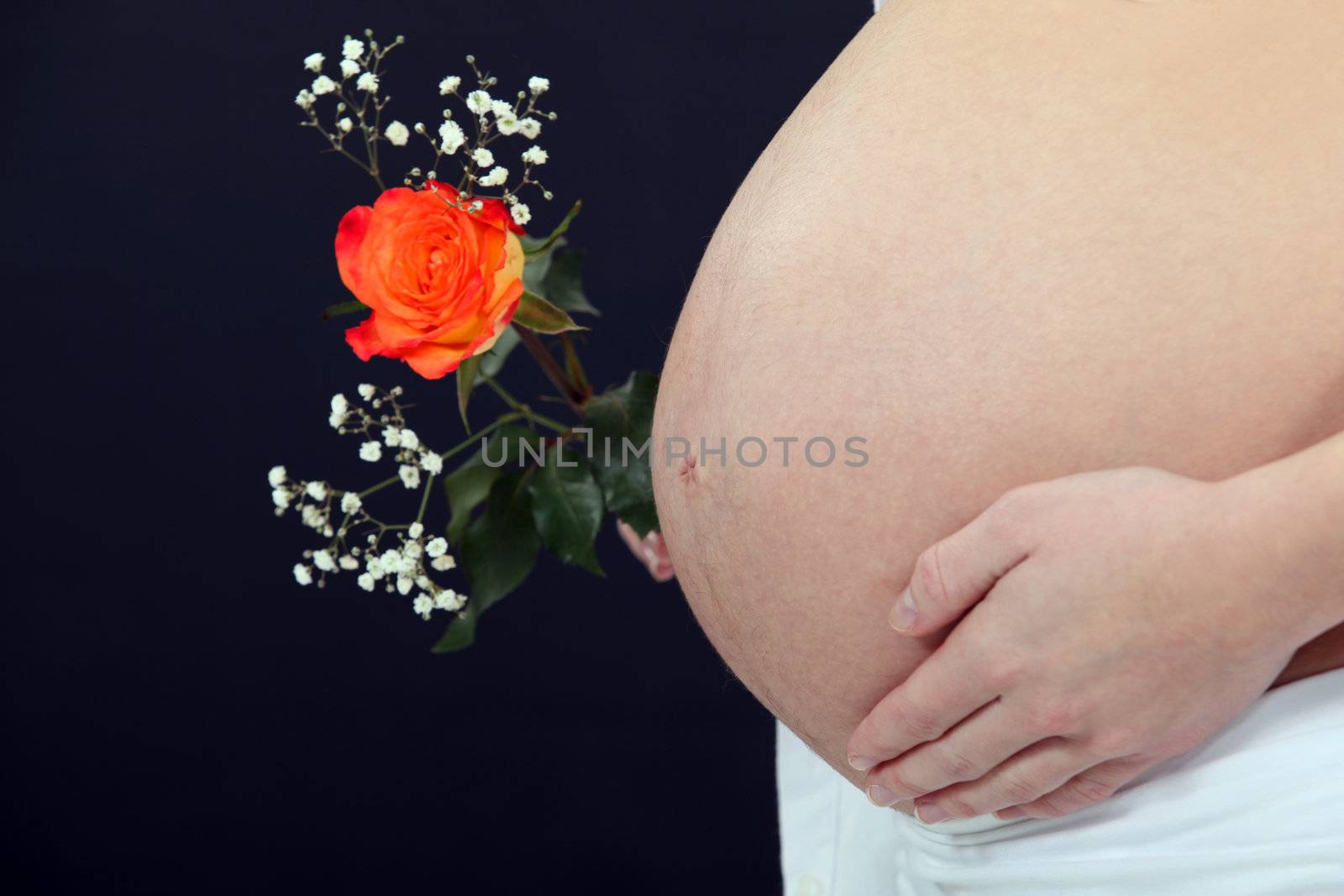 A pregnant woman with a flower.
