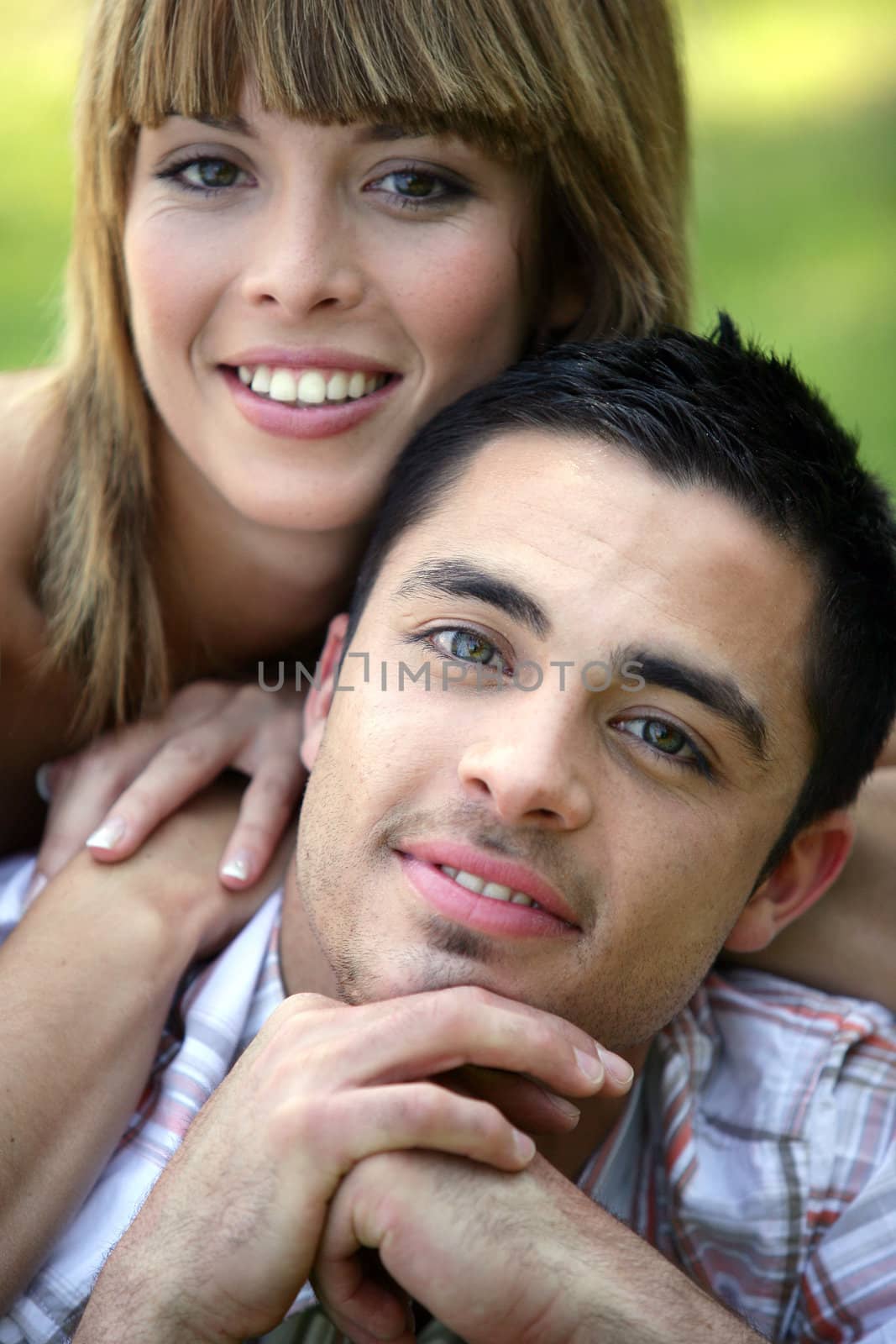 portrait of smiling young couple by phovoir